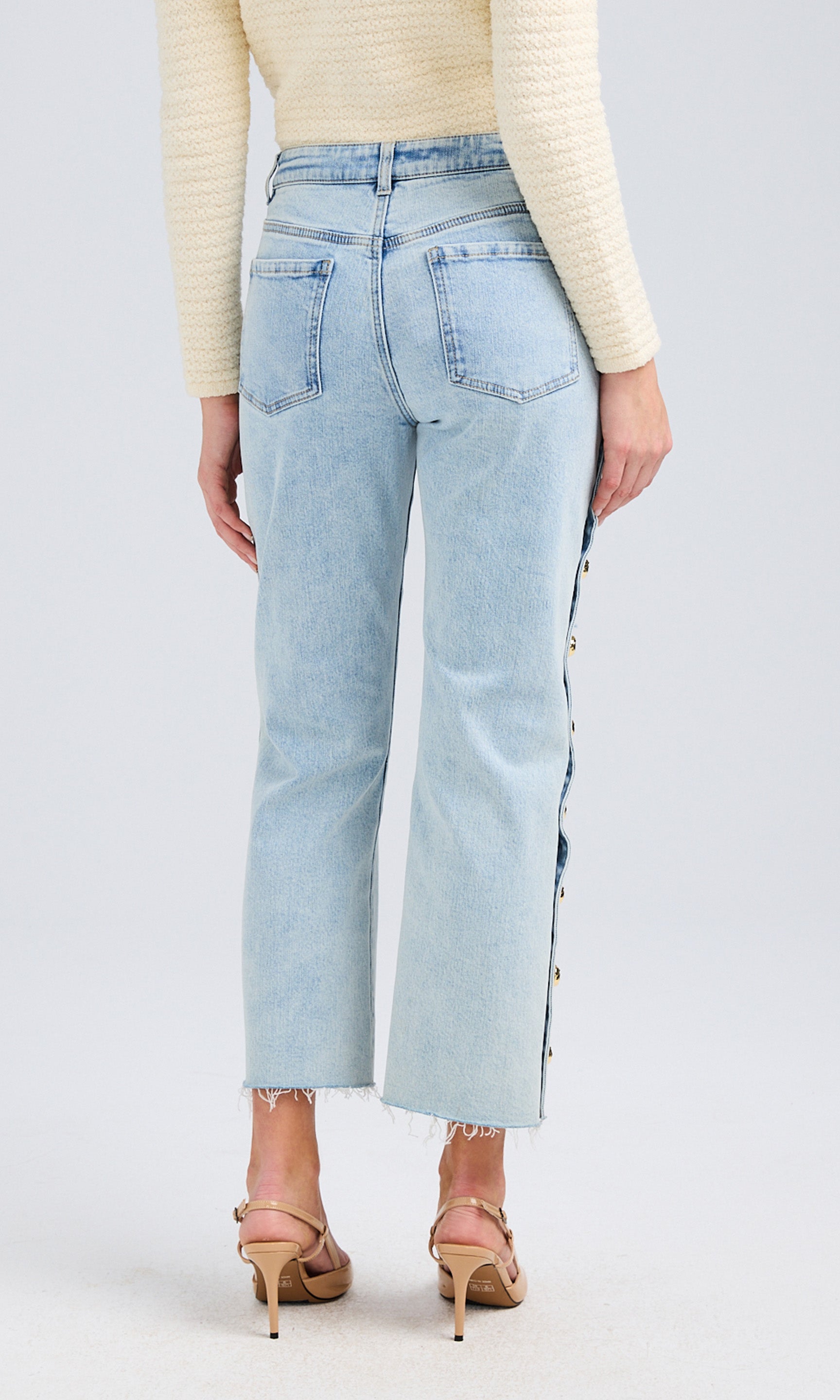 Rear view highlighting the structured back pockets, belt loops, and tailored fit.