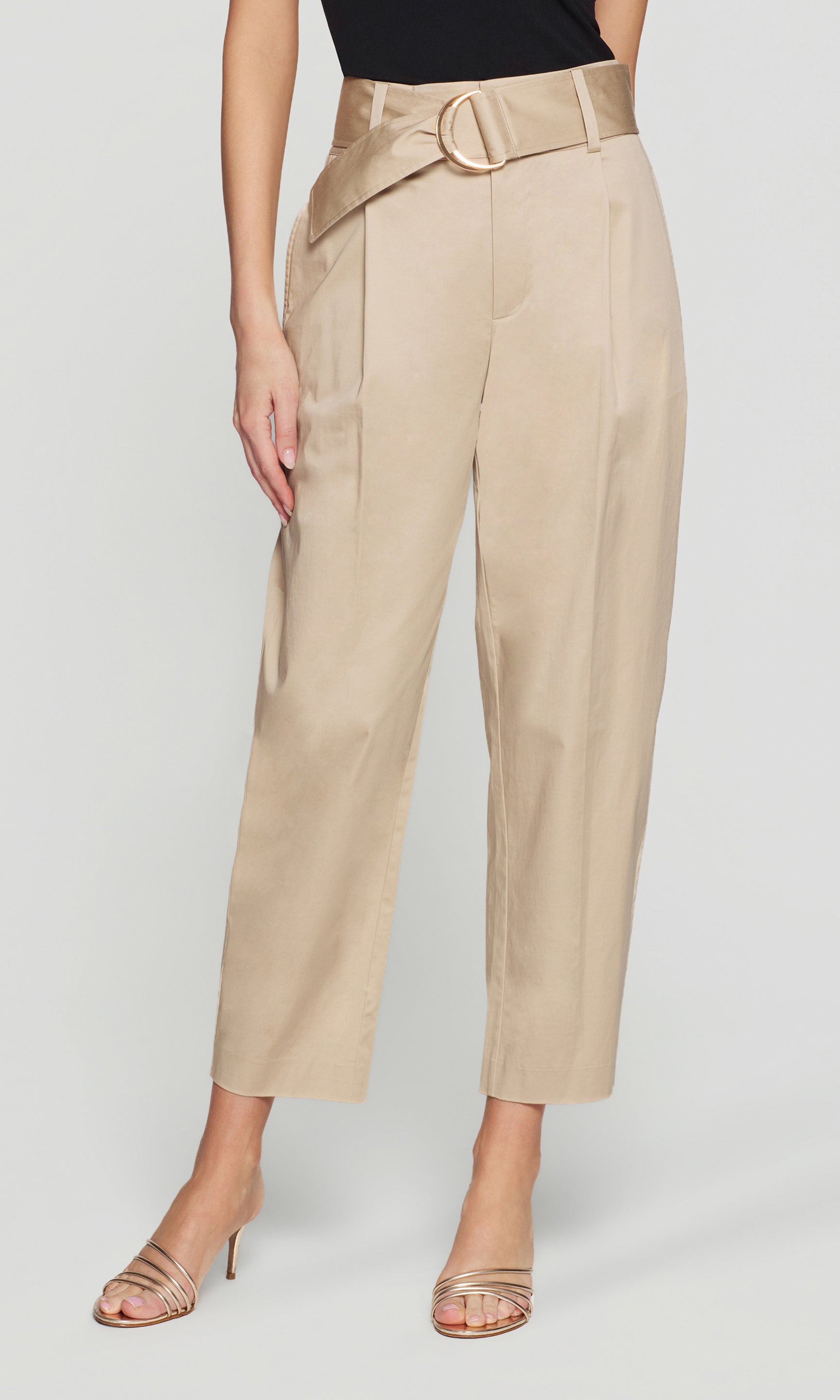 Model wears the Cassie Cotton Sateen Pants in light khaki in a front view (cropped from waist to heels), highlighting the high-rise fit and tapered leg.