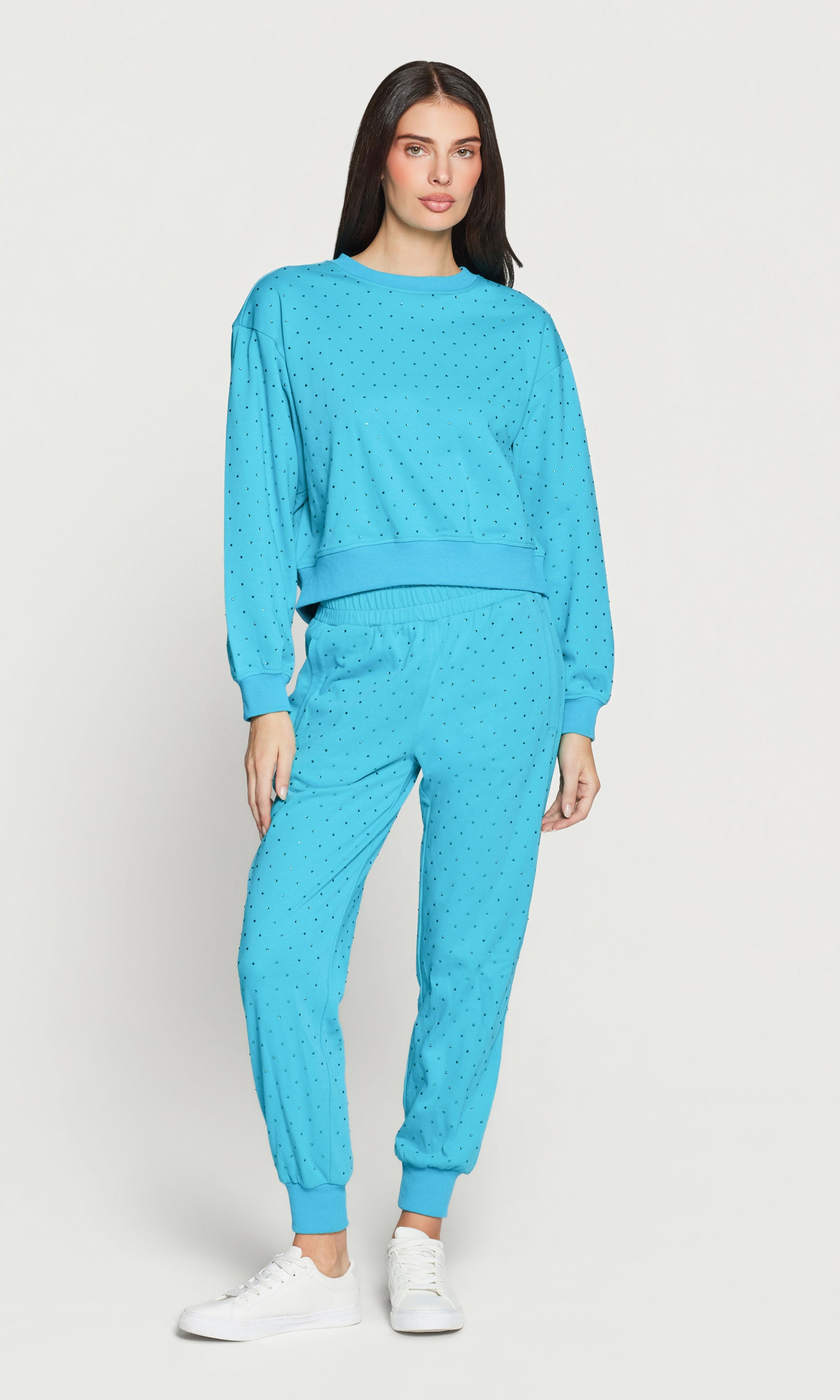 Woman wearing a blue tracksuit on a white background