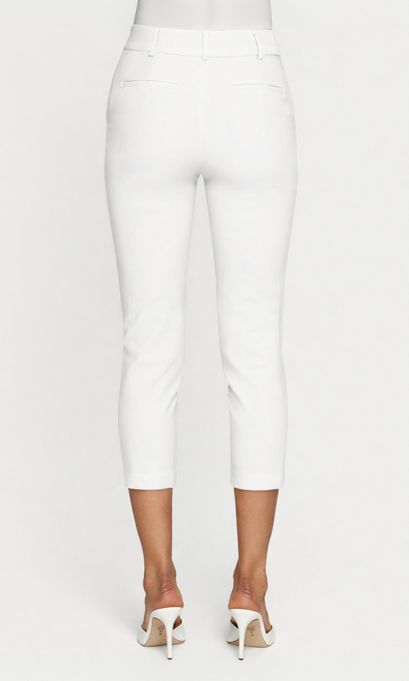 Back view of white pants worn by a person on a white background