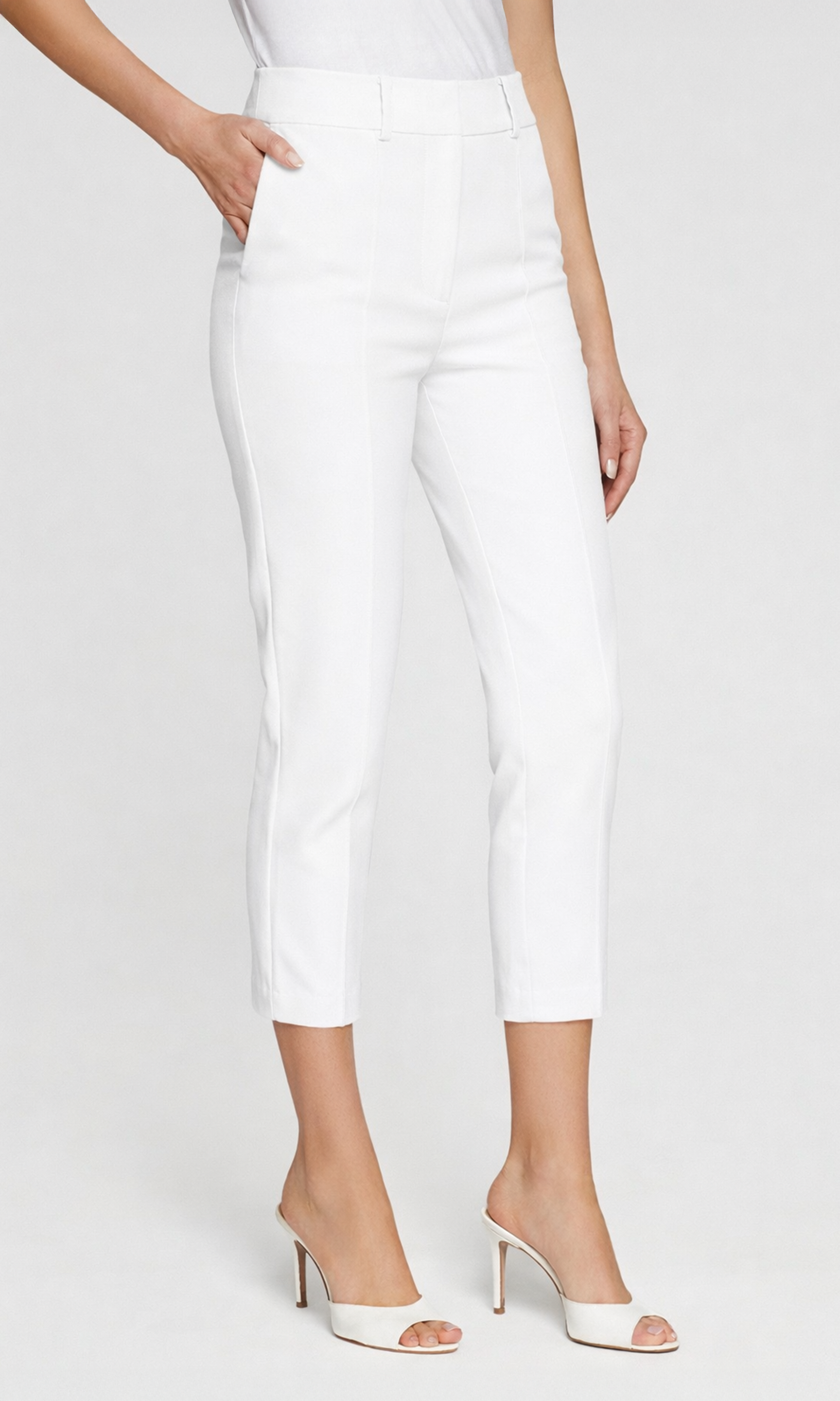 White pants worn by a person on a white background