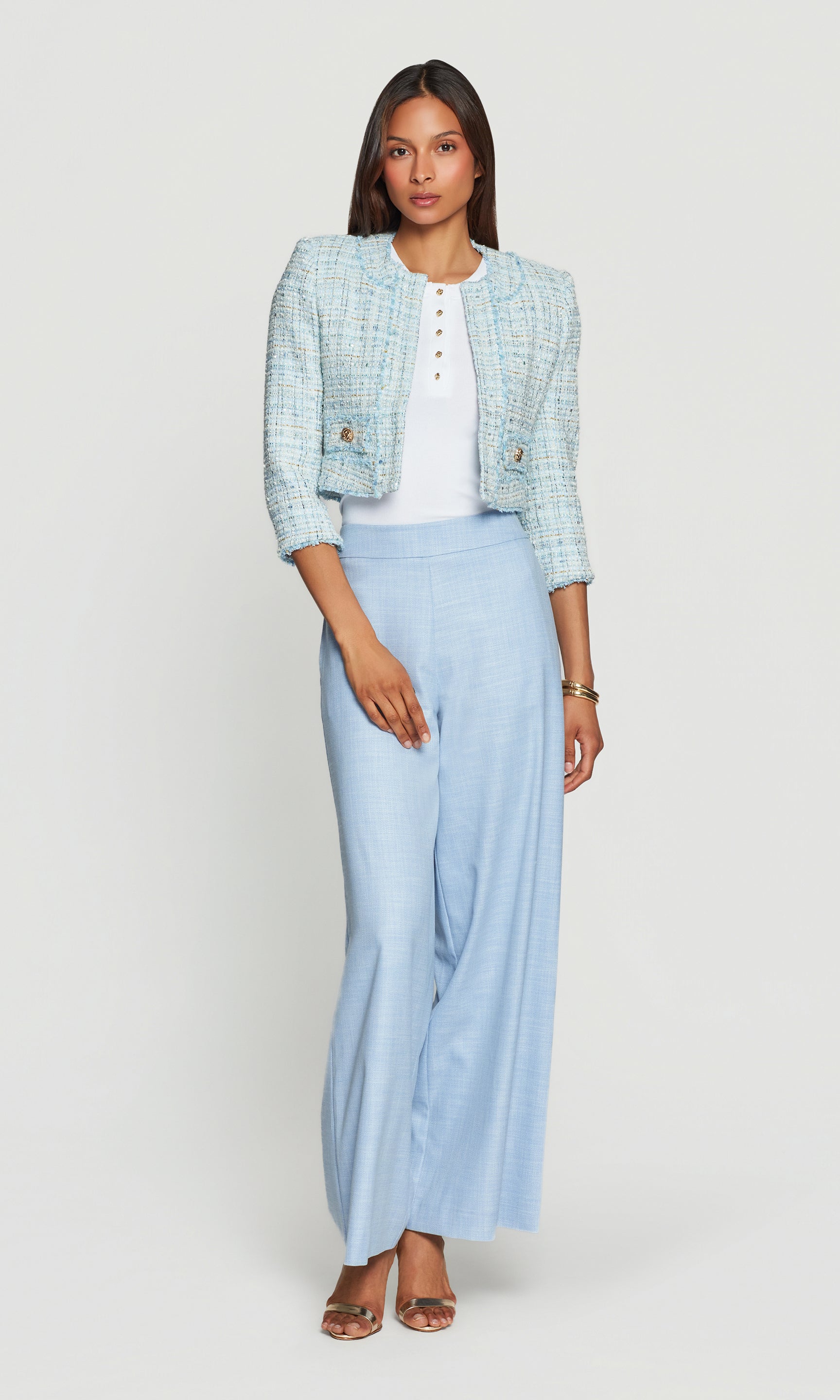 Model wears the Salvador Tweed Blazer in aqua melange in a full-body front view, paired with aqua trousers for a coordinated look.