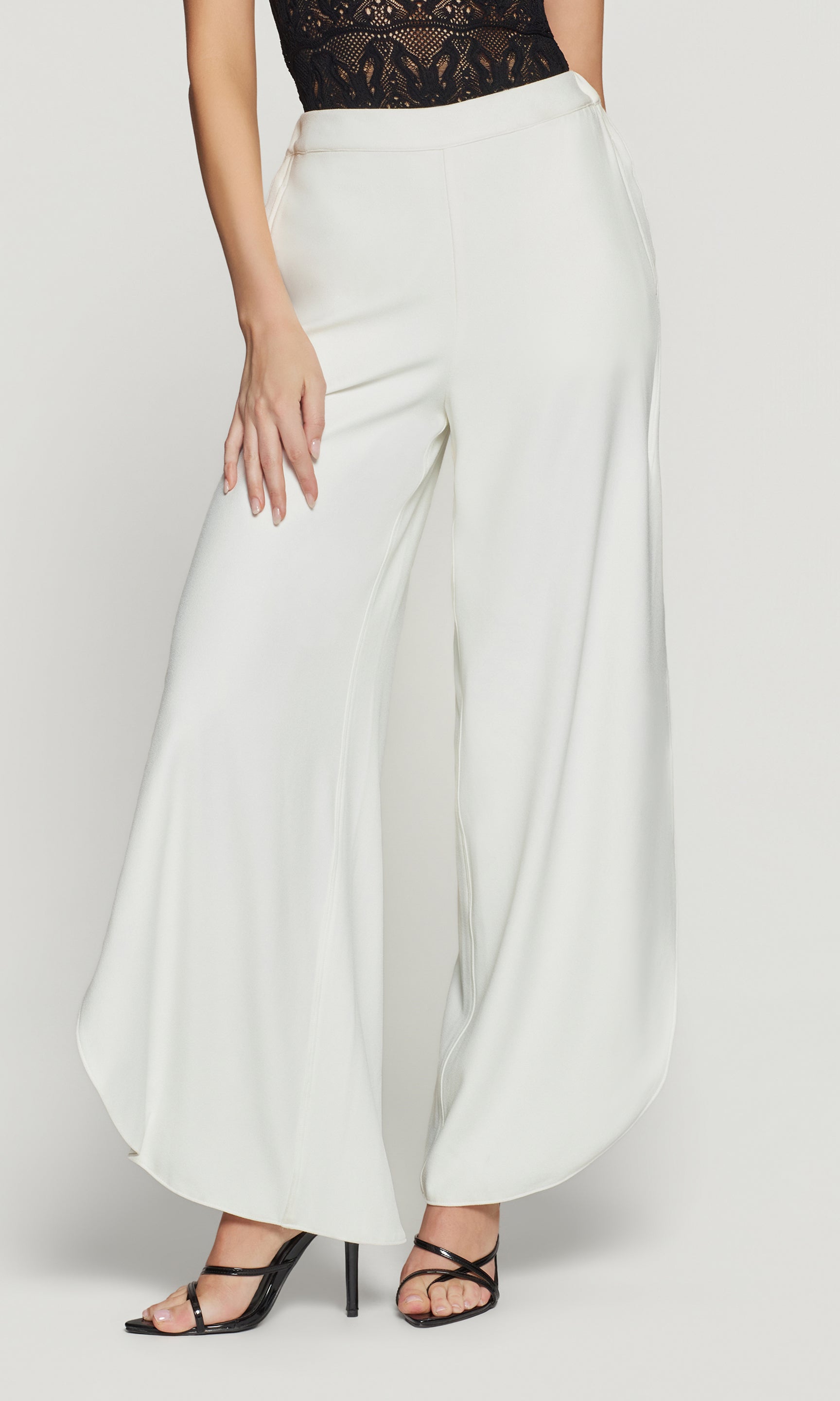White wide-leg pants worn by a person on a white background