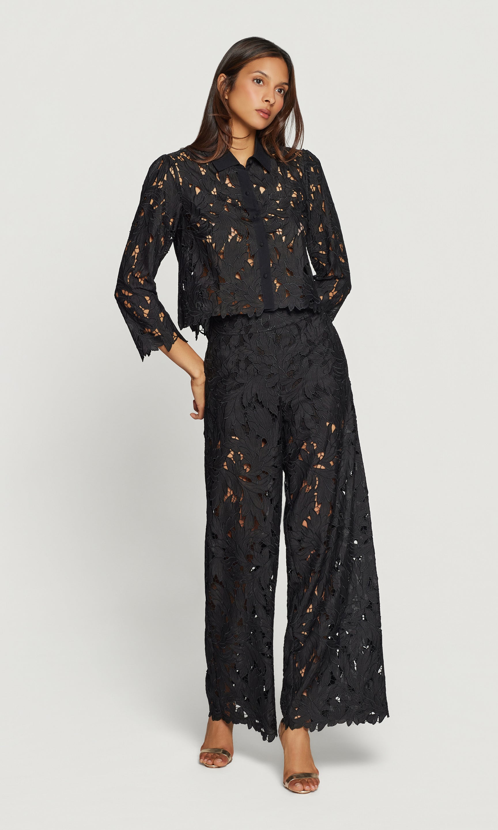 Woman wearing a black lace outfit on a white background