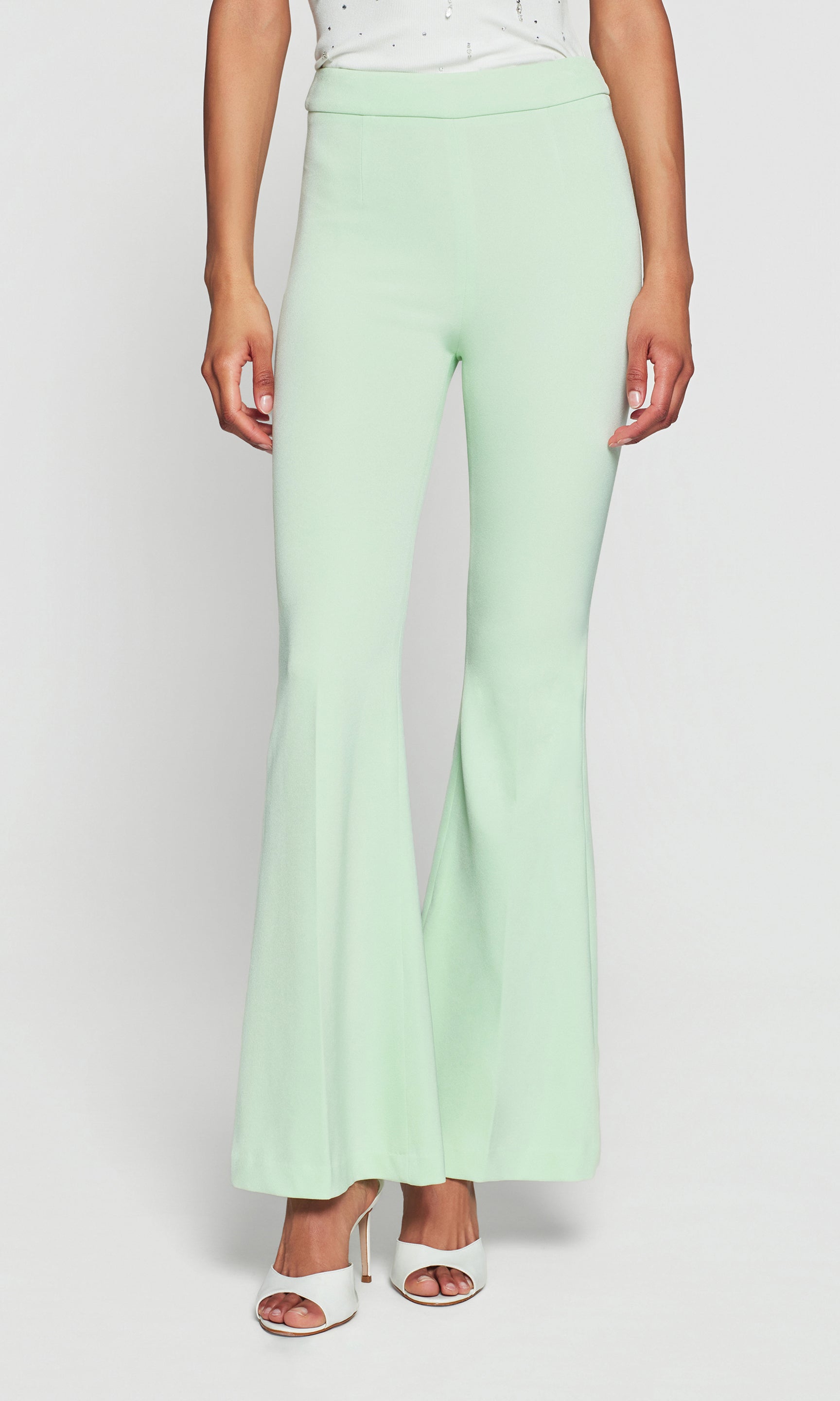 Model wears the Wesley Lightweight Crepe Pants in mint, close-up front detail view of the waistband and seam, showing the crisp crepe texture and structured fit.