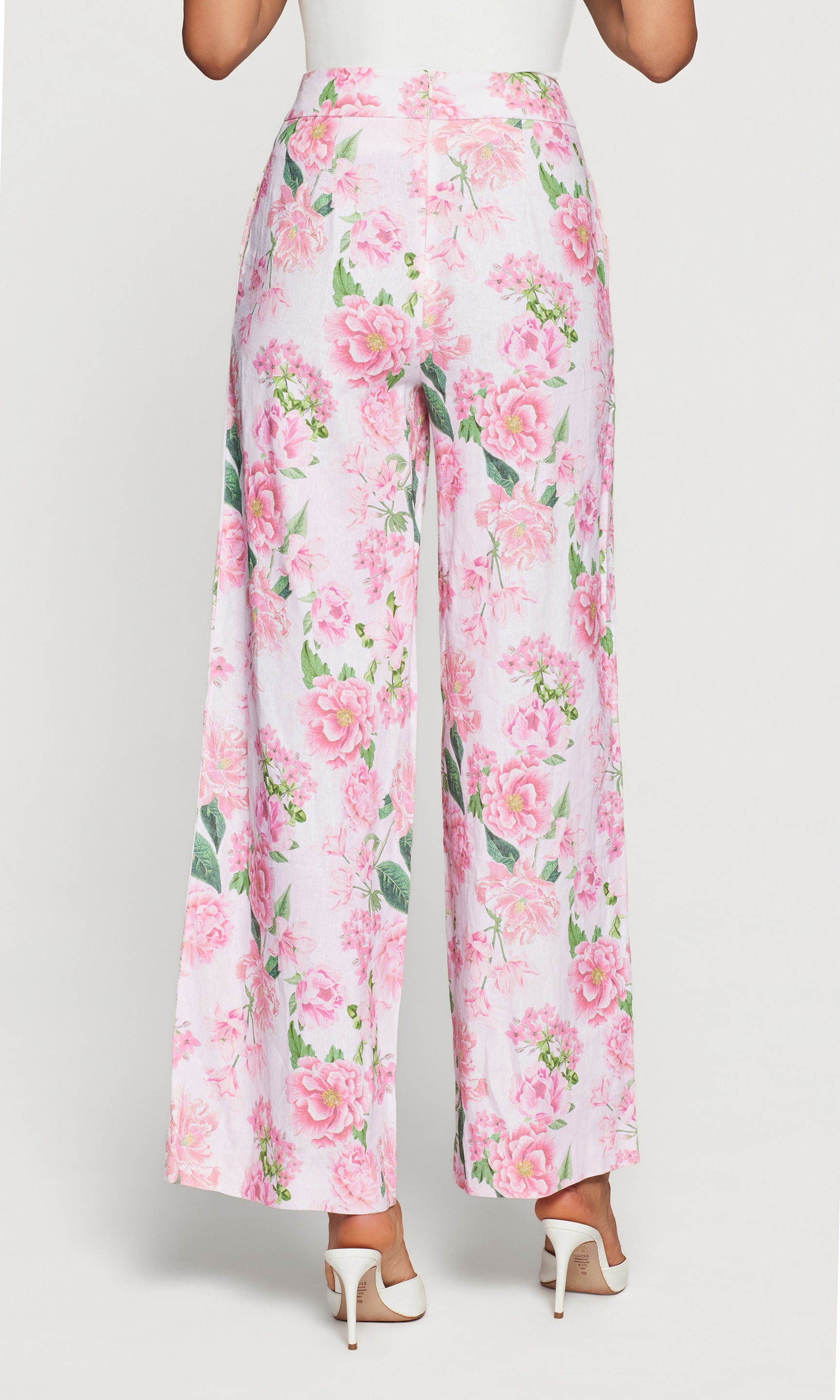 Back view of floral pants with pink flowers on a white background