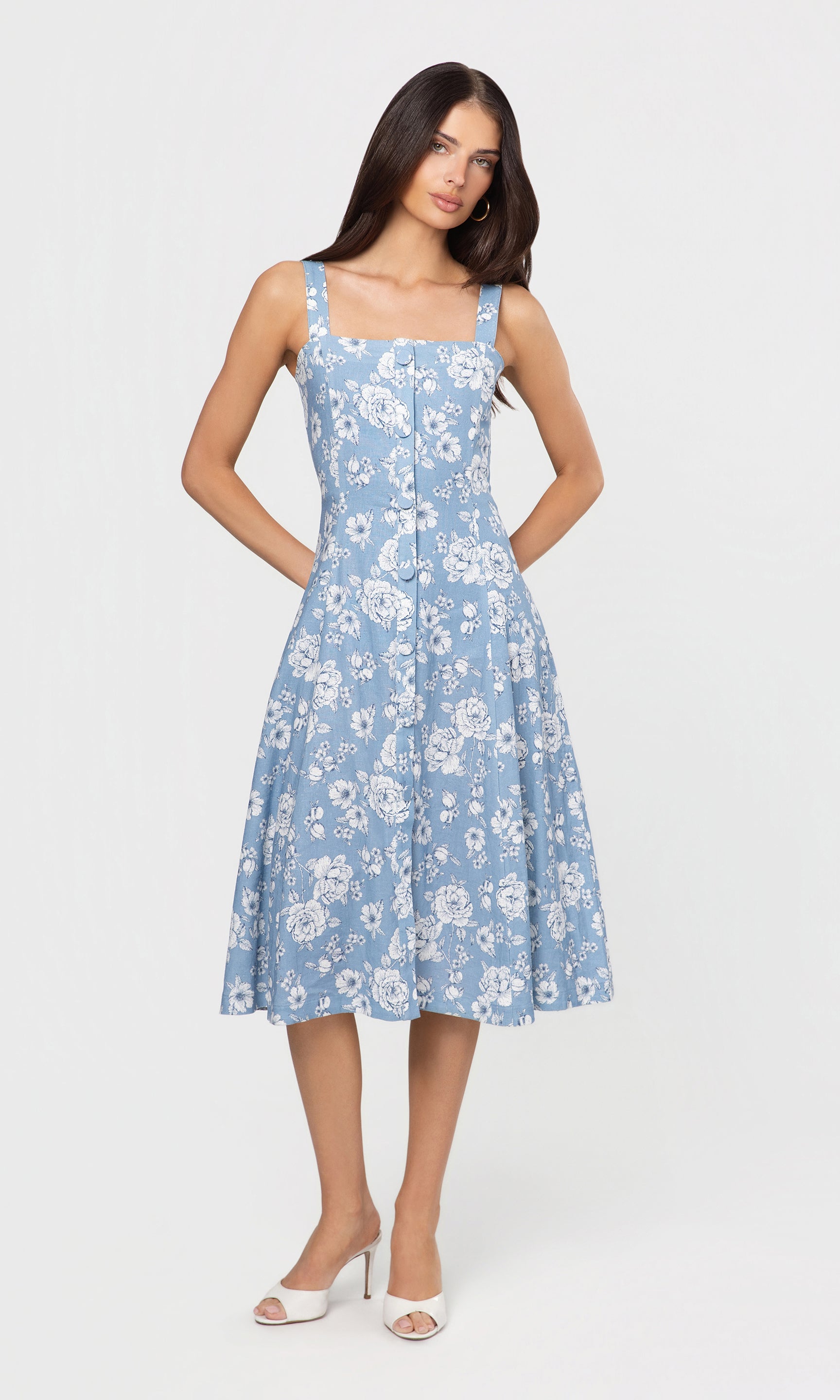 Woman wearing a blue floral dress on a white background