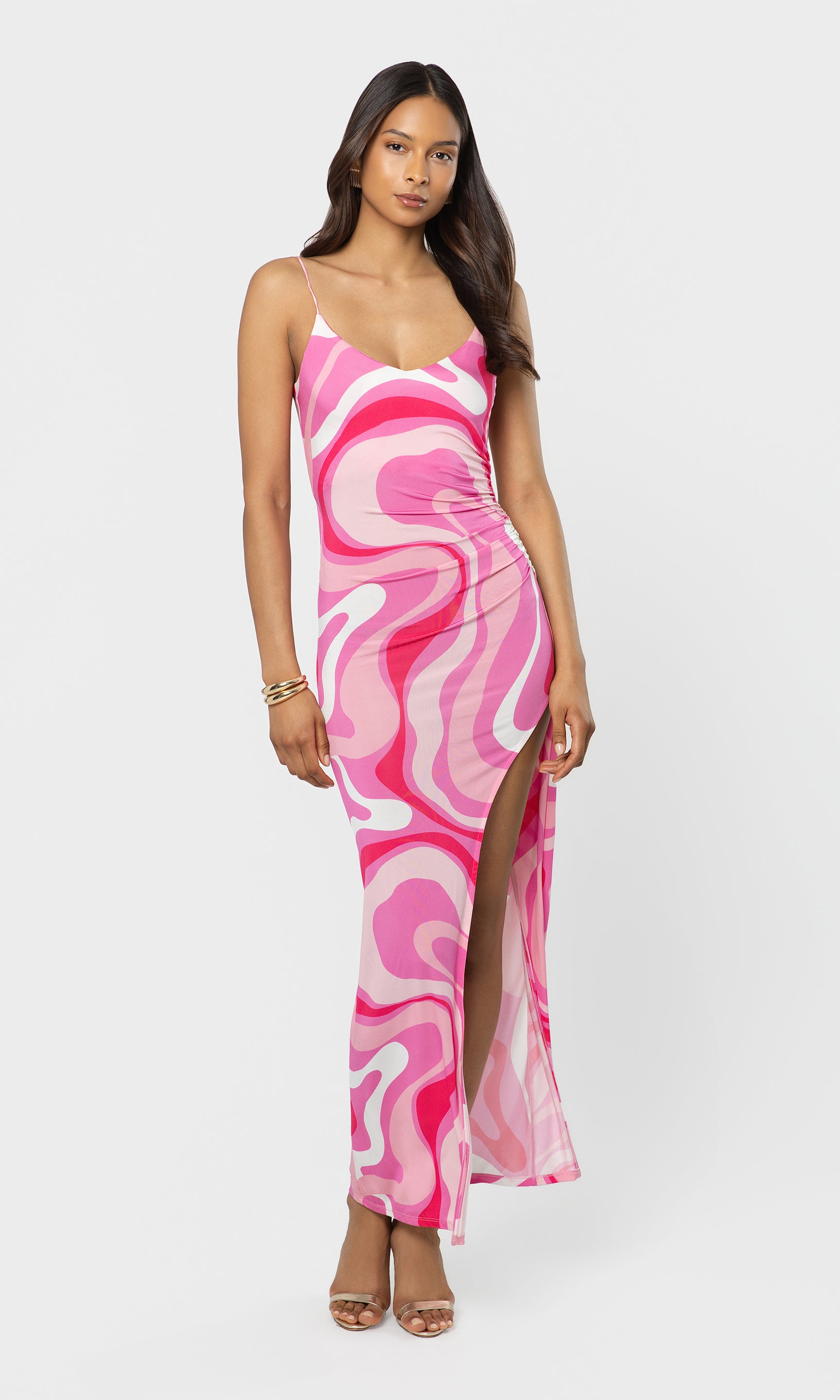 Woman wearing a pink and white patterned dress on a white background