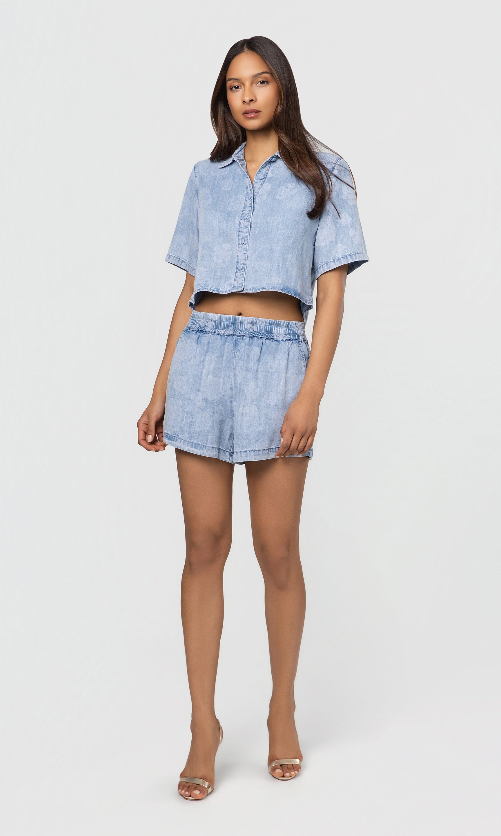 Woman wearing a denim outfit on a white background