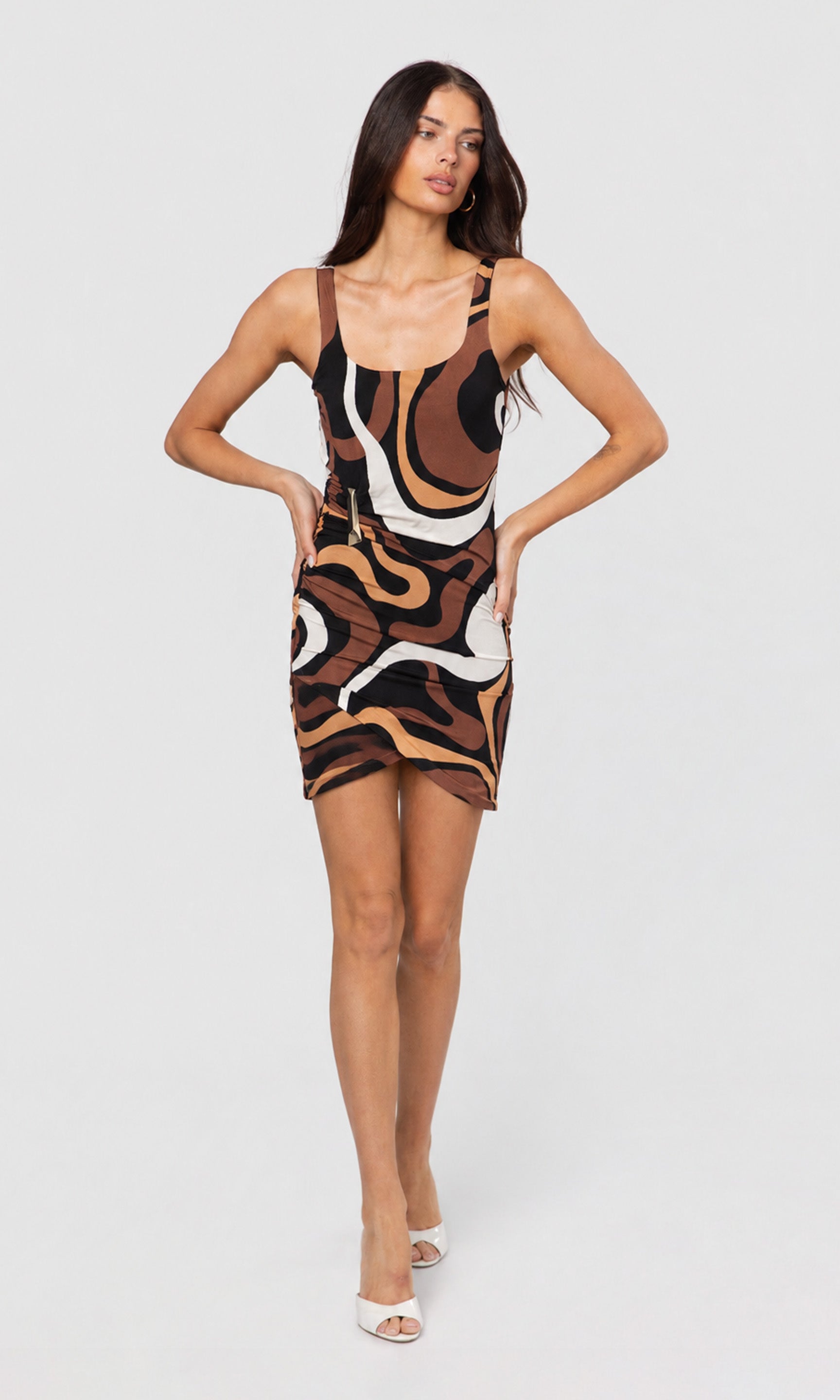 Woman wearing a patterned dress on a white background