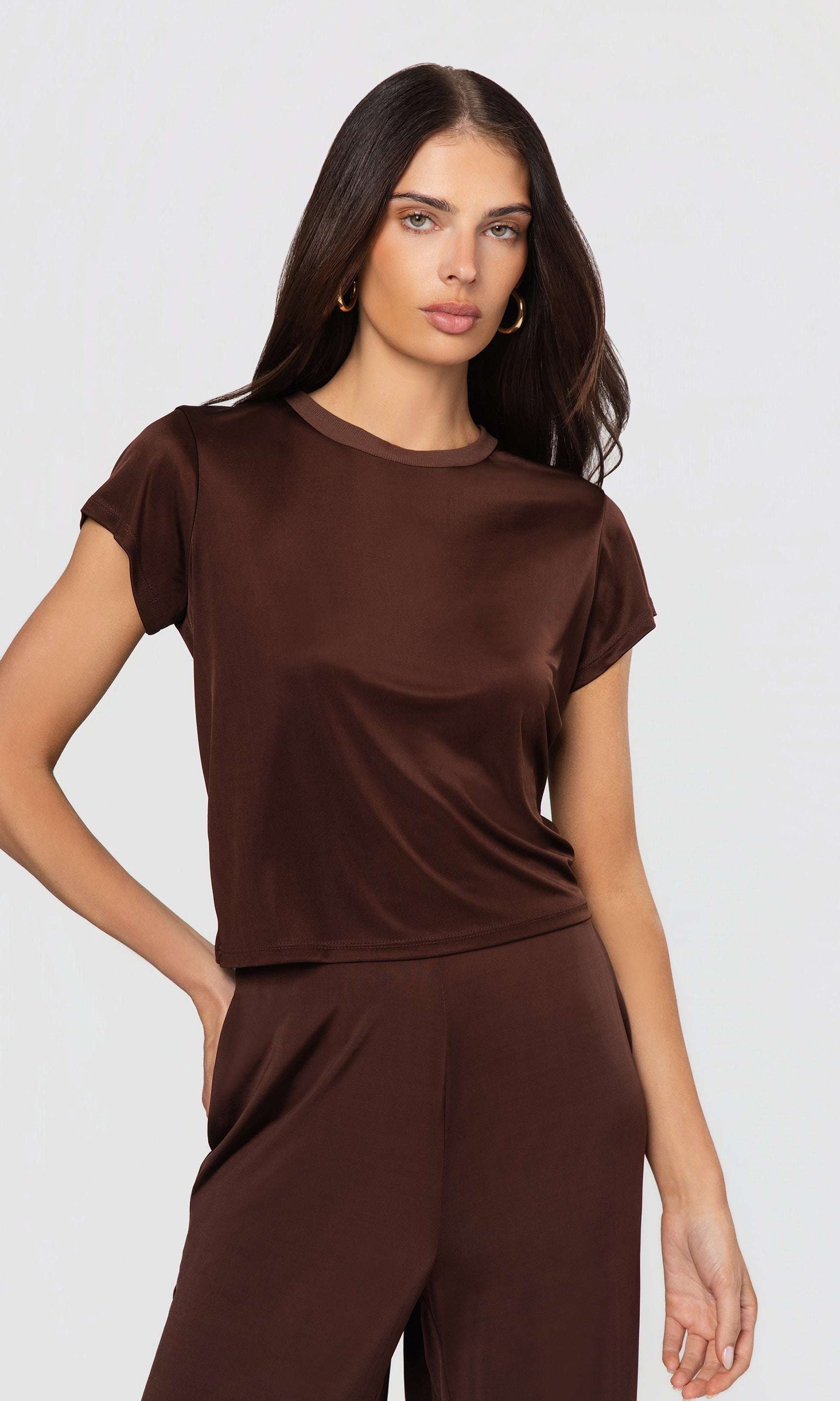 Woman wearing a brown outfit on a white background