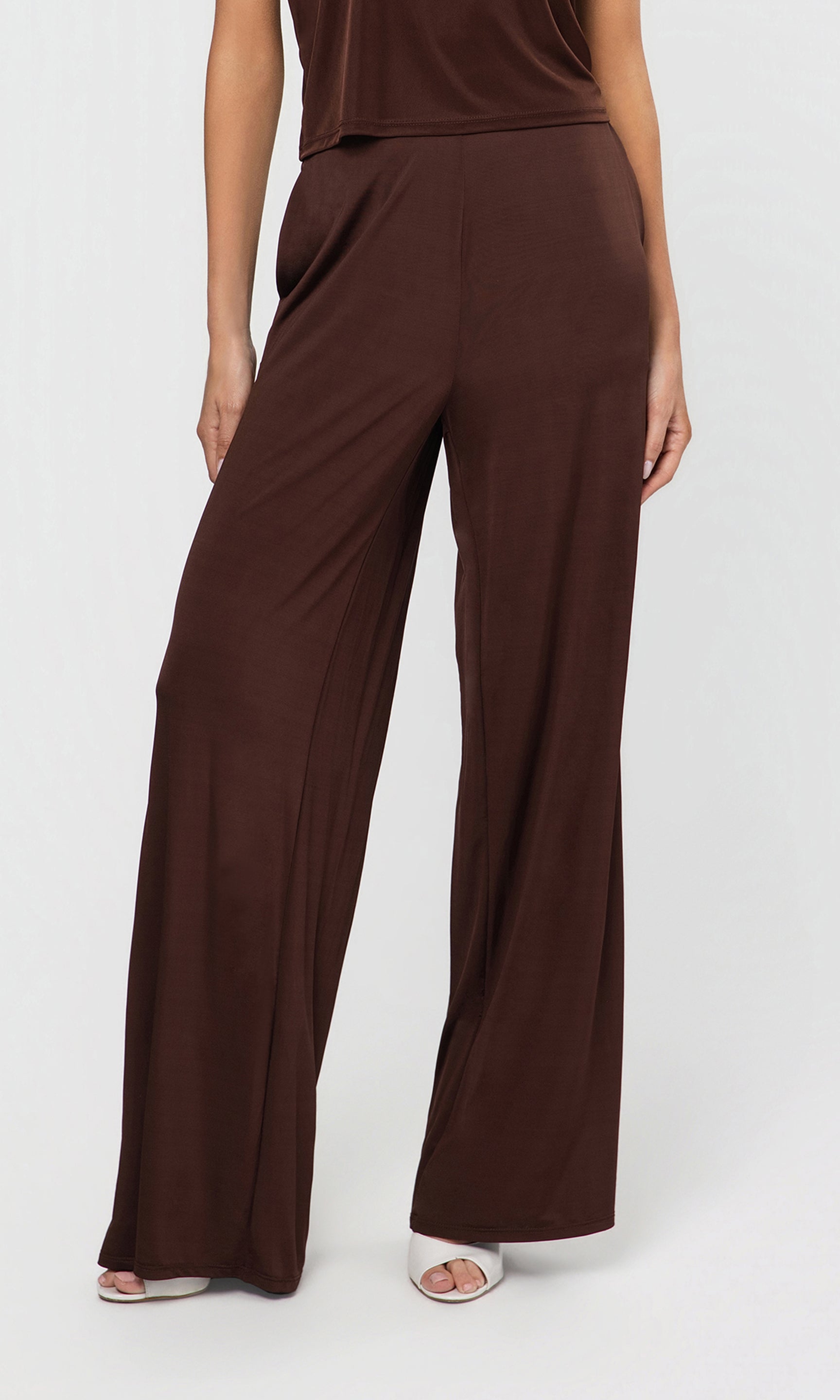 Brown wide-leg pants worn by a person on a white background