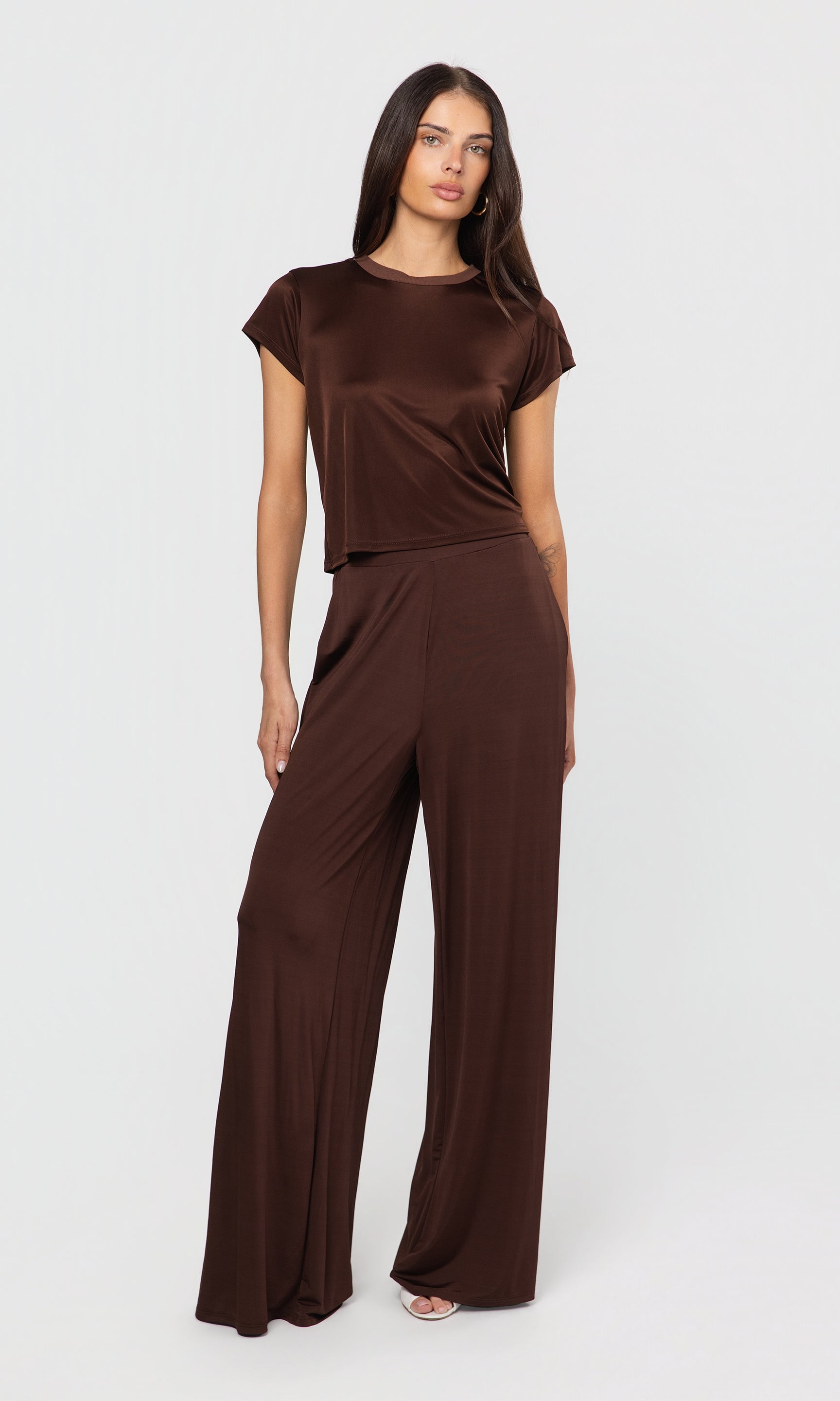 Woman wearing a brown outfit on a white background