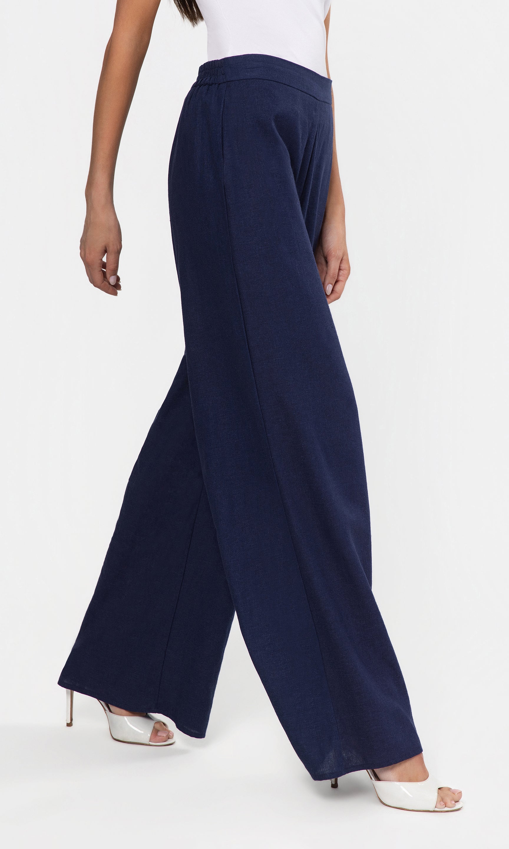 Side view of navy wide-leg pants worn by a person on a white background