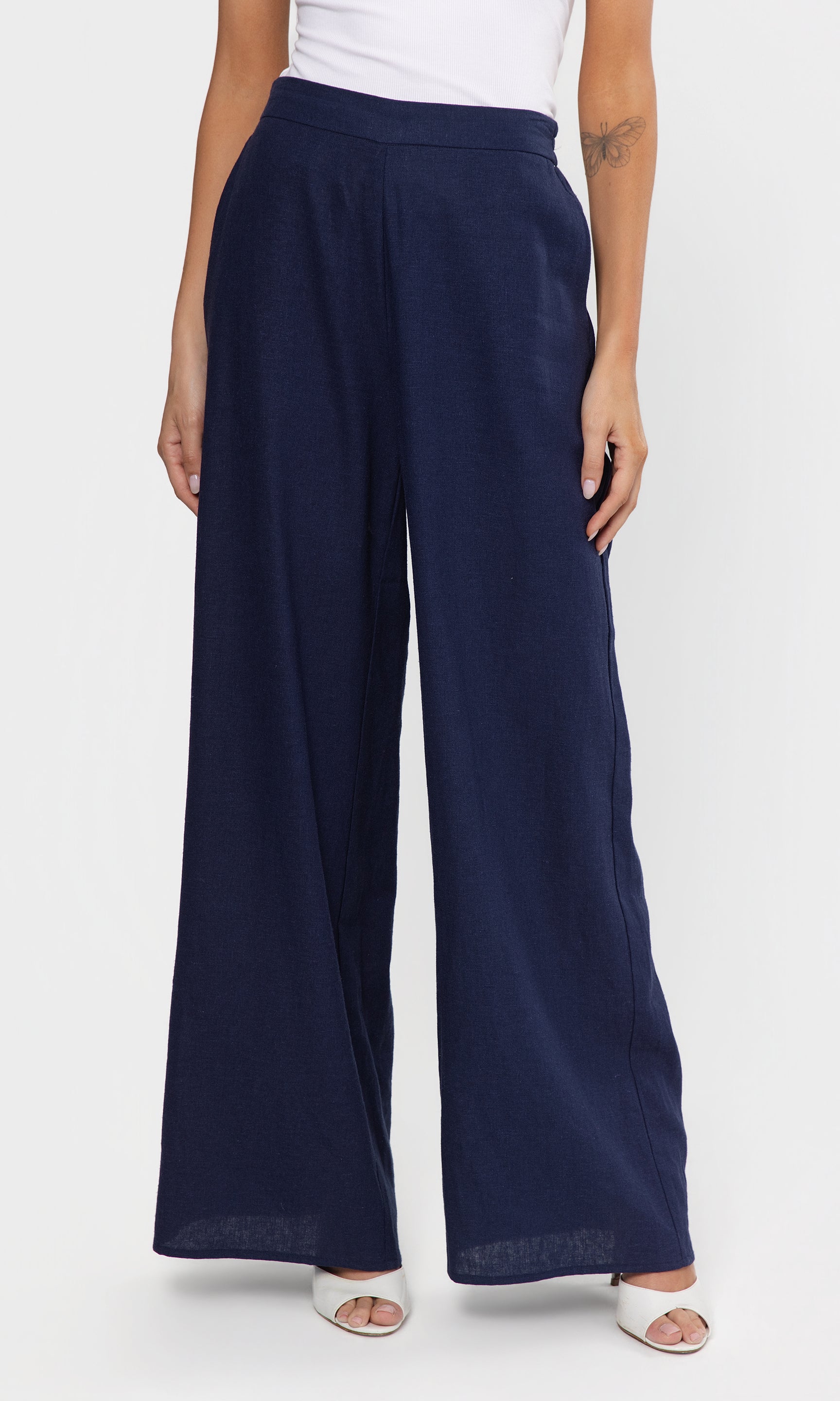 Navy wide-leg pants worn by a person on a white background