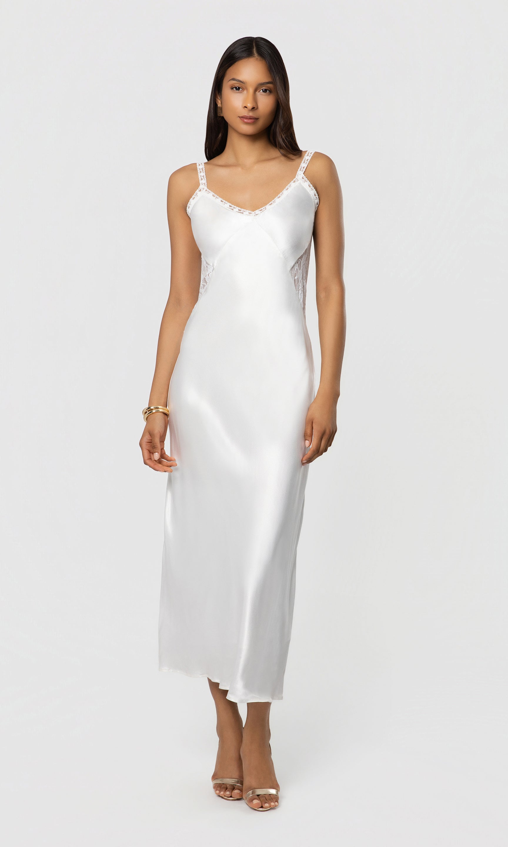 Woman wearing a white satin dress on a white background