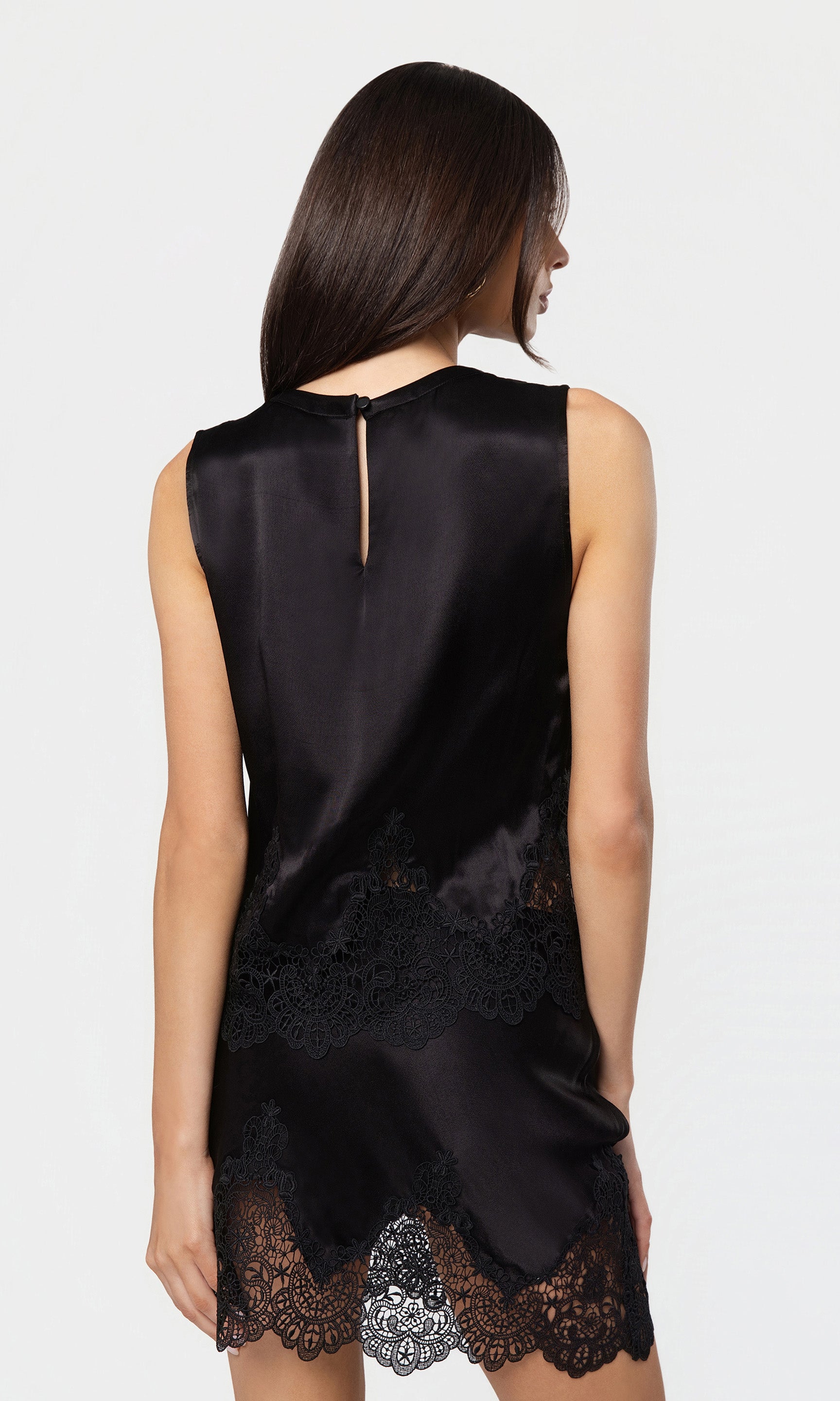 Back view of black satin tank and skirt with lace details on a white background