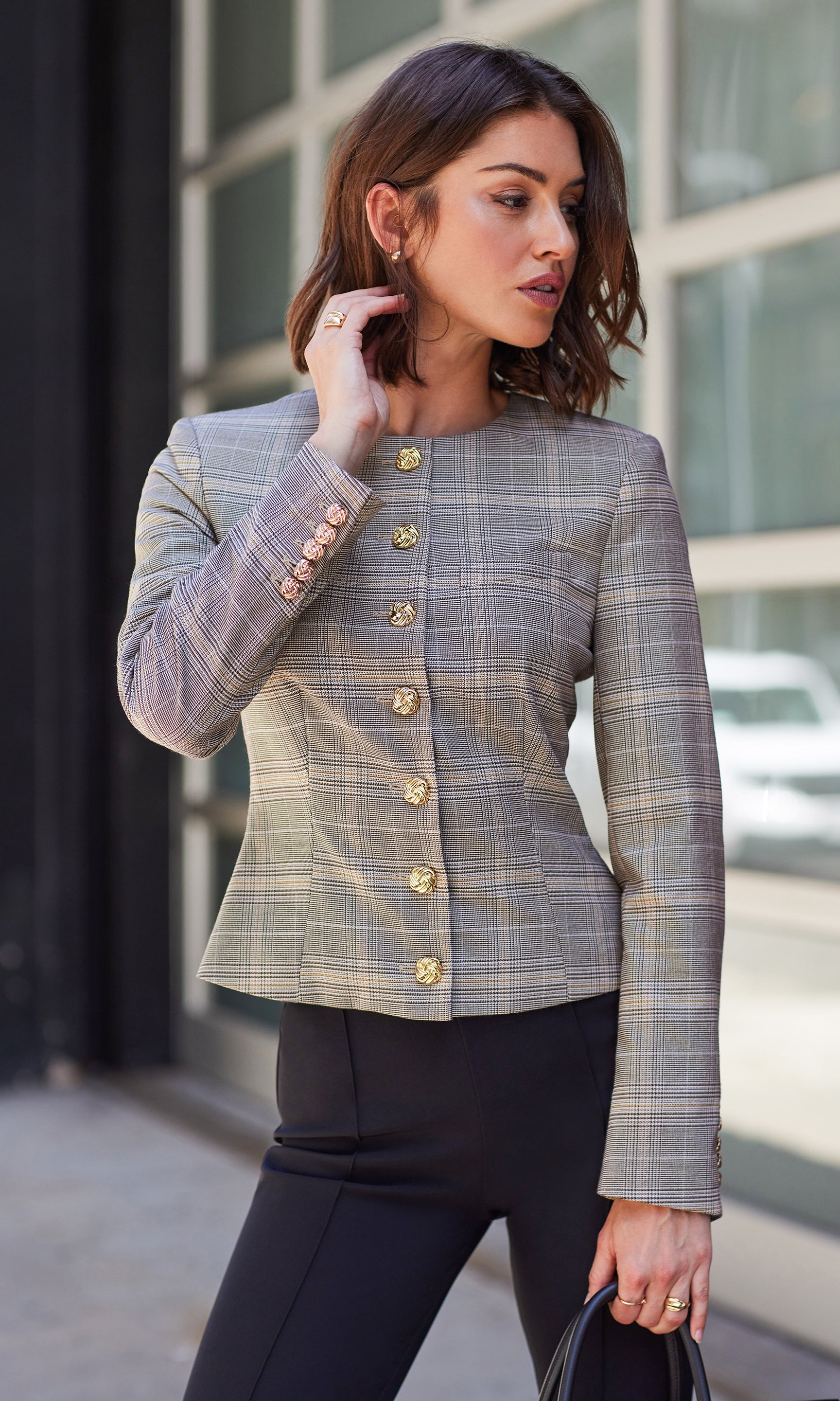 Side view of the Sirus Plaid Jacket paired with black pants, walking outside in natural light.