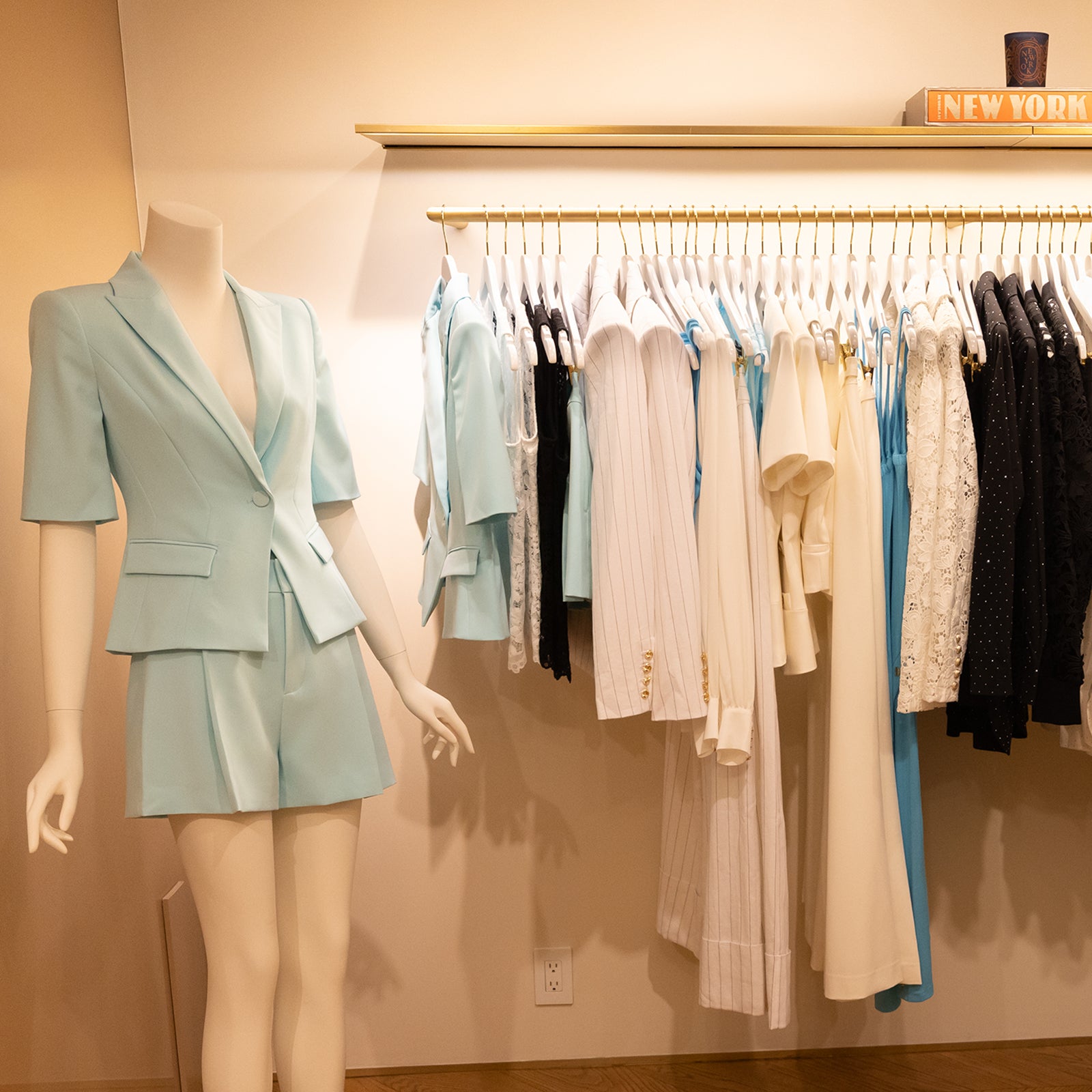 image of gen love summer styles on a rack at our Madison store with a mannequin to the left displaying our aqua crepe set
