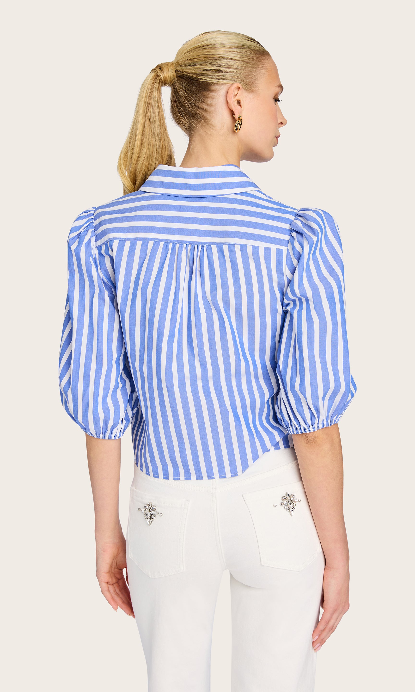 Rear view of the model highlighting the back yoke and relaxed drape of the Tammy Wide Stripe Shirt.