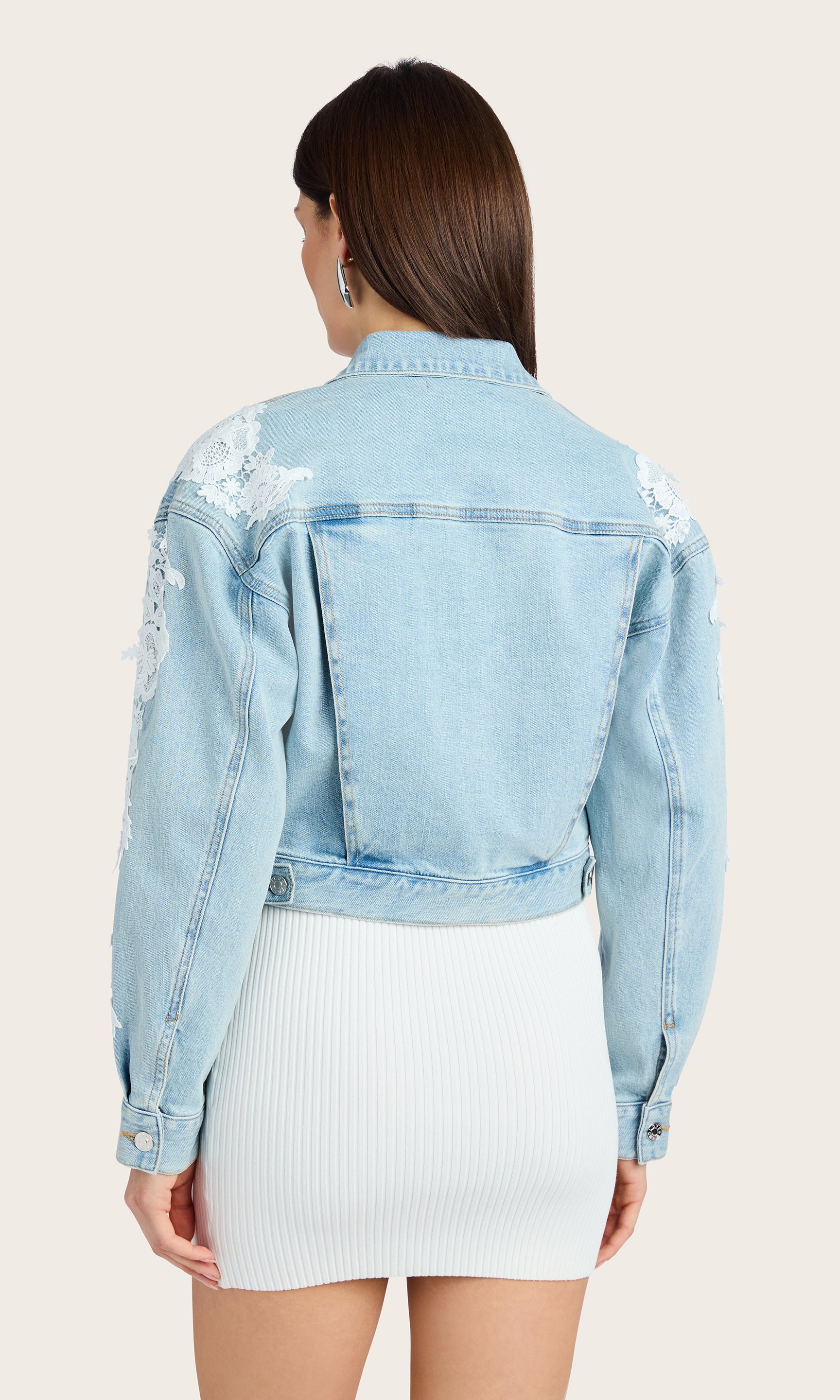 Back view of the Valex Lace Combo Denim Jacket styled with a white dress