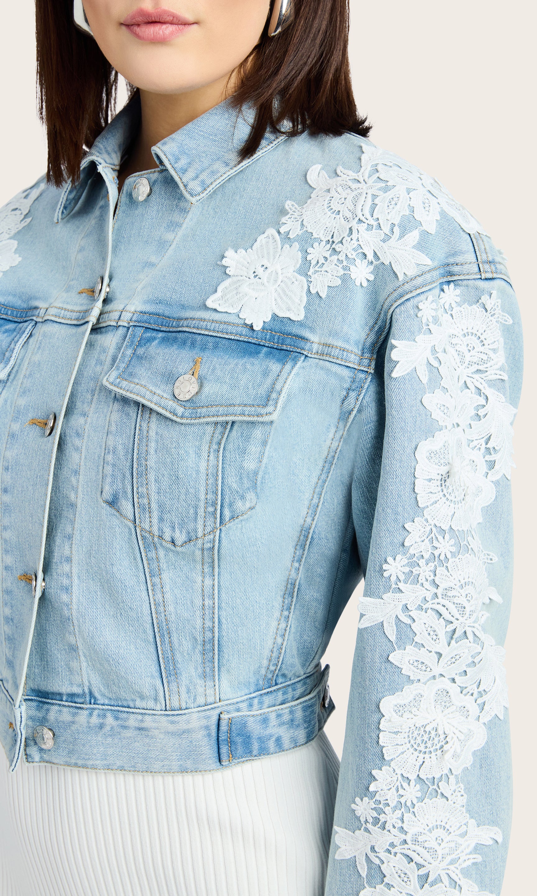 Detail view of the Valex Lace Combo Denim Jacket showcasing the white lace floral details on the side of the jacket.