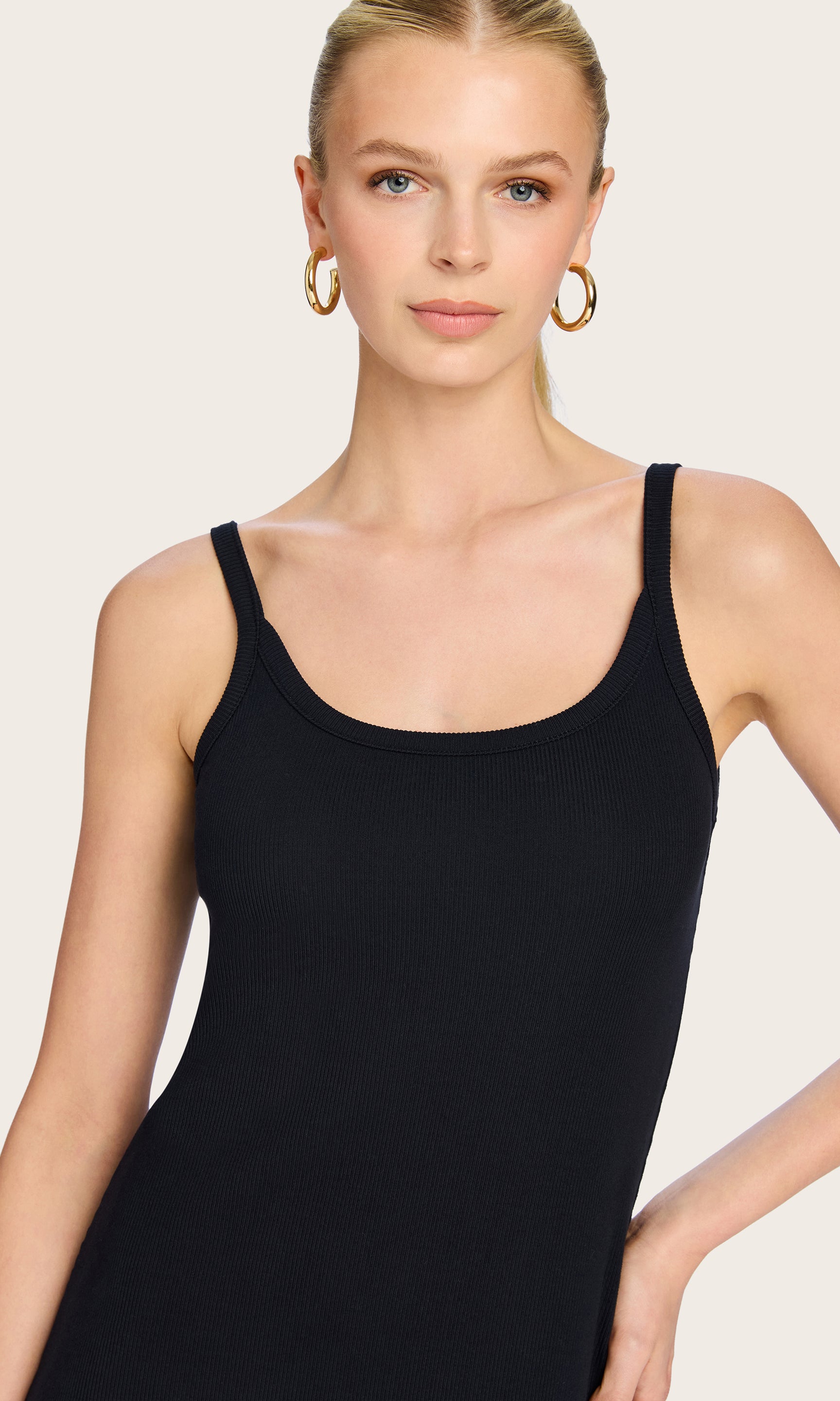 Close-up front view of the model in the Veneta Snap Dress, showcasing the clean tank neckline and smooth ribbed fabric.