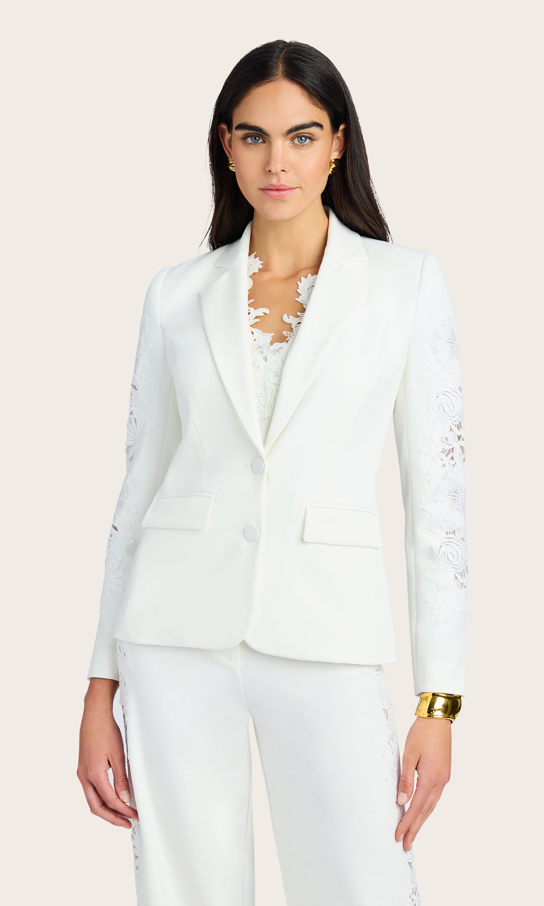 Front view of the model in the Venturi Lace Combo Blazer styled with white pants, showcasing the sharp tailoring.