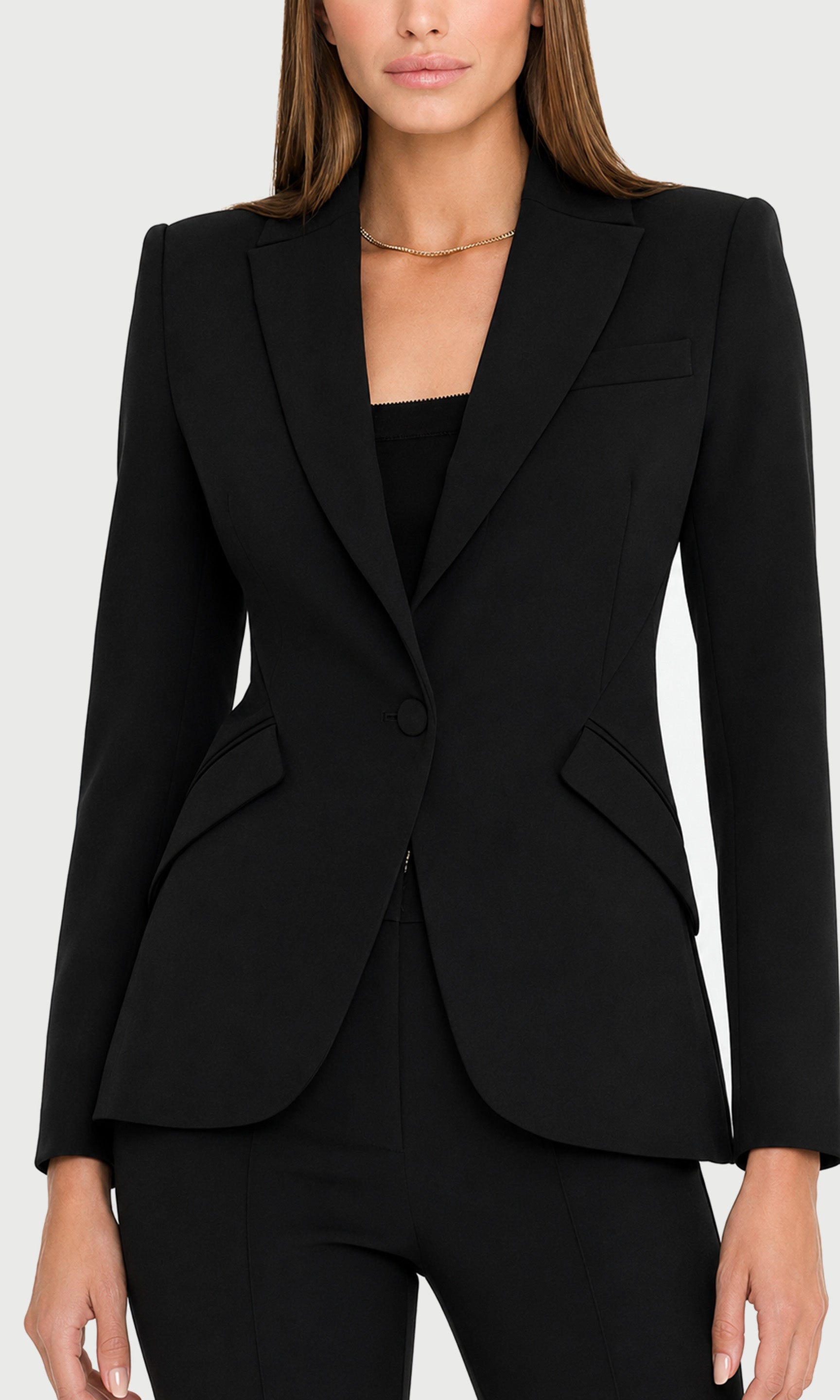 Close-up of black suit jacket worn by a person on a white background