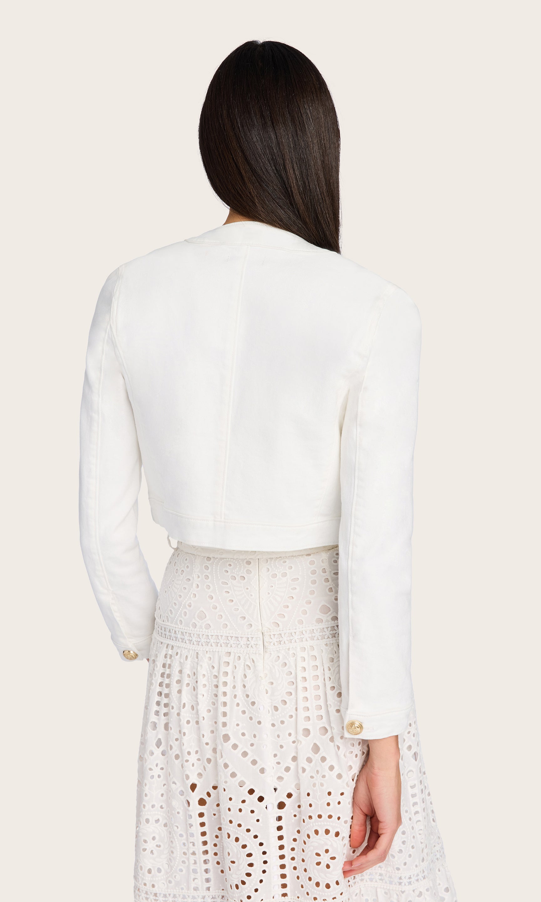 In this rear angle, the model wears the Valentina Denim Jacket to emphasize the clean, collarless back and structured seams.