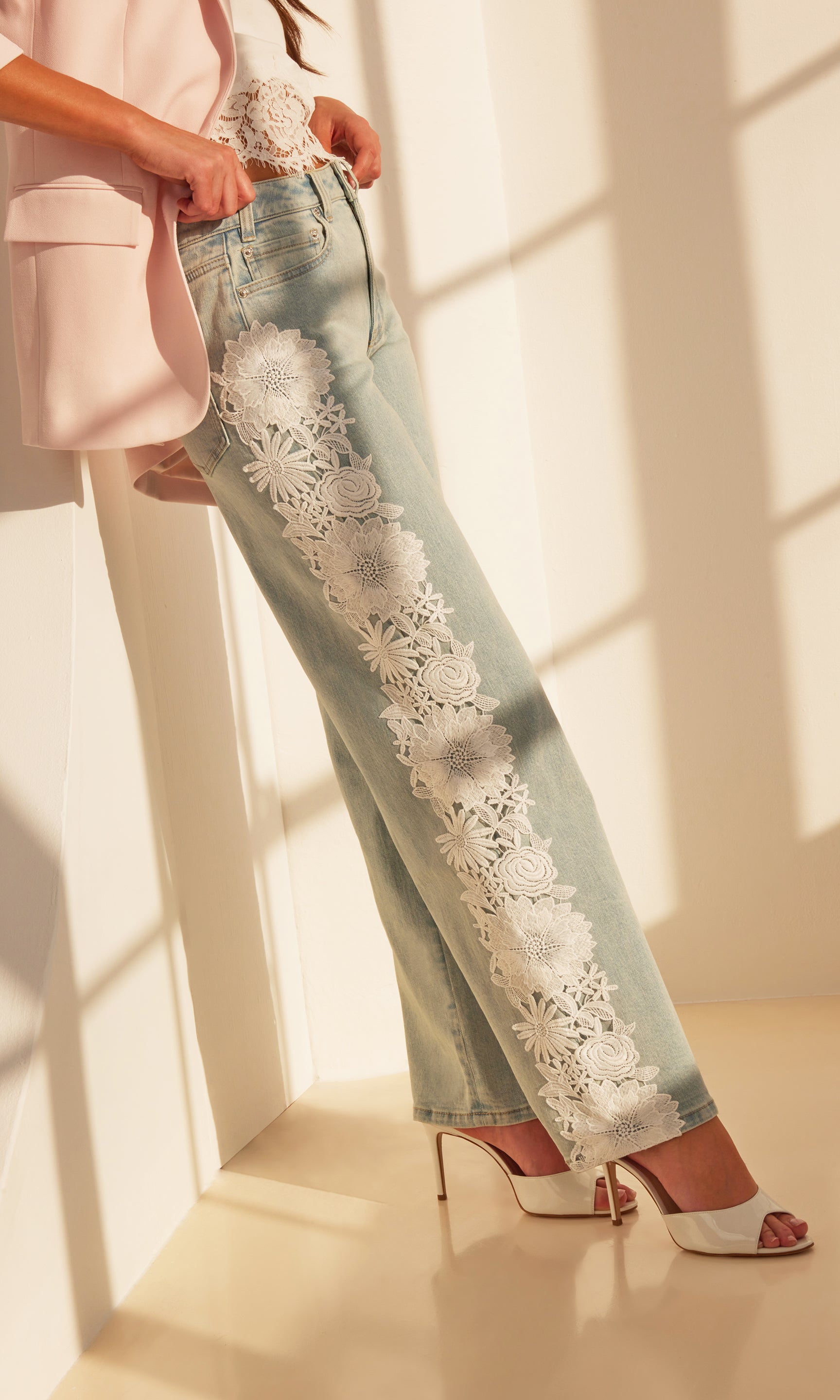 Indoor shot of the Jethro Lace Combo Denim Jeans styled with heels