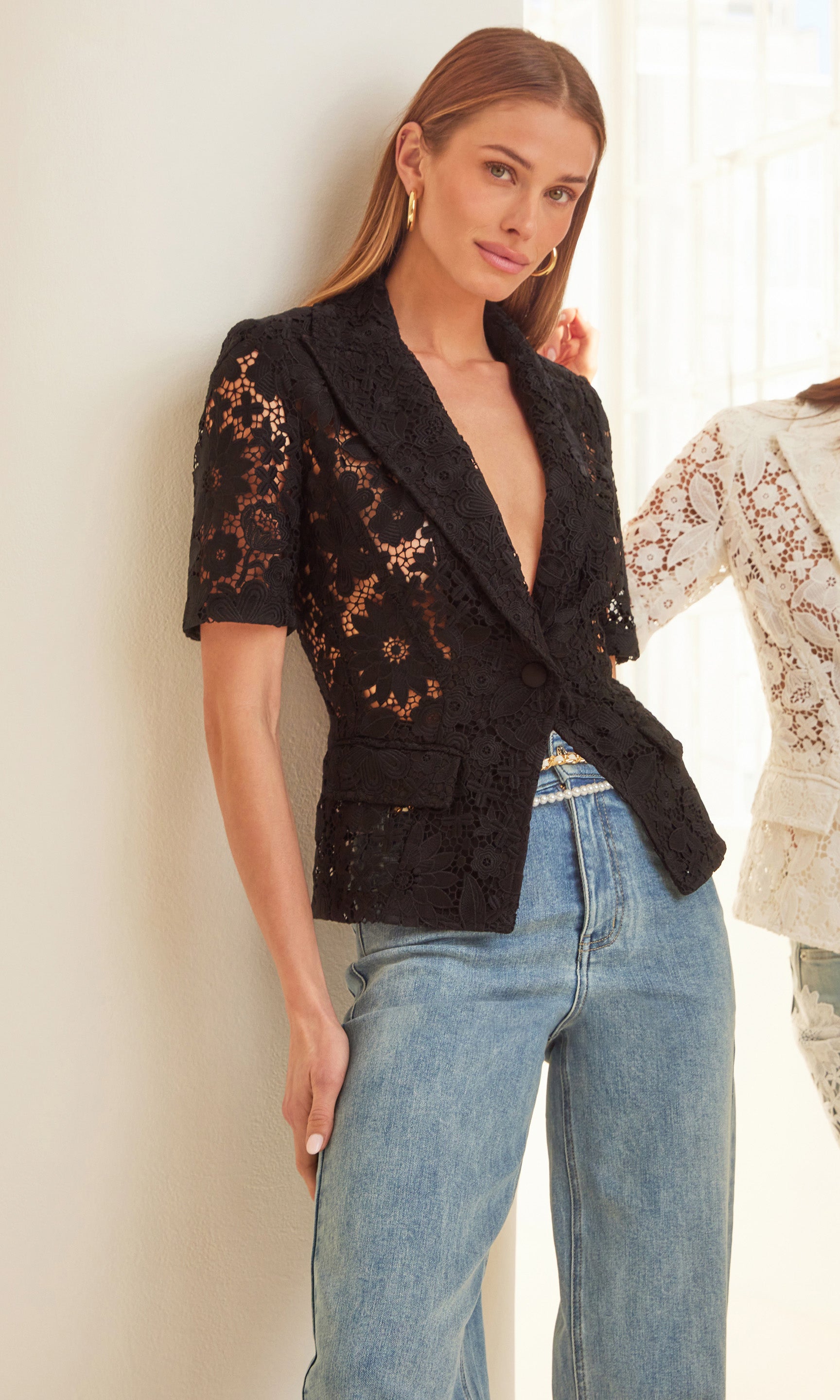 Indoor shot of the model wearing the Melbourne Lace Blazer with jeans for a modern editorial look