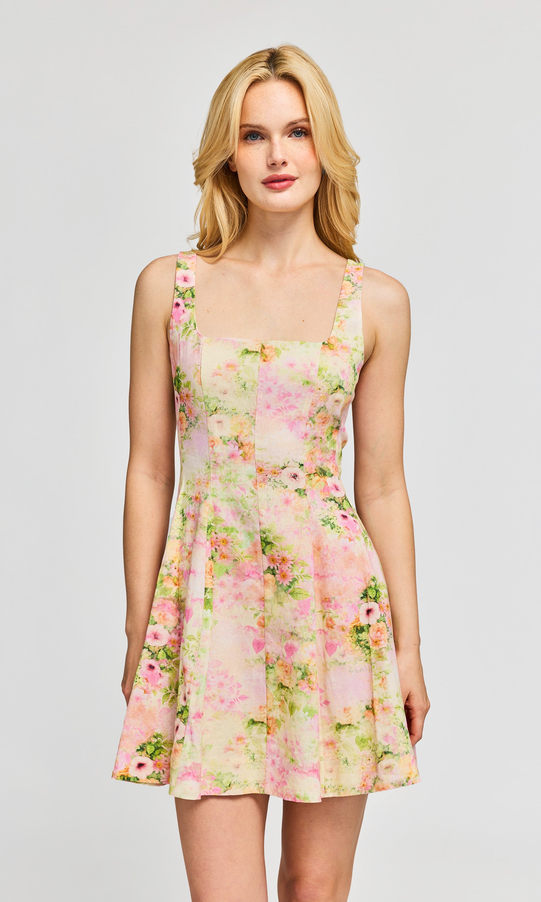 Woman wearing a floral dress on a plain background