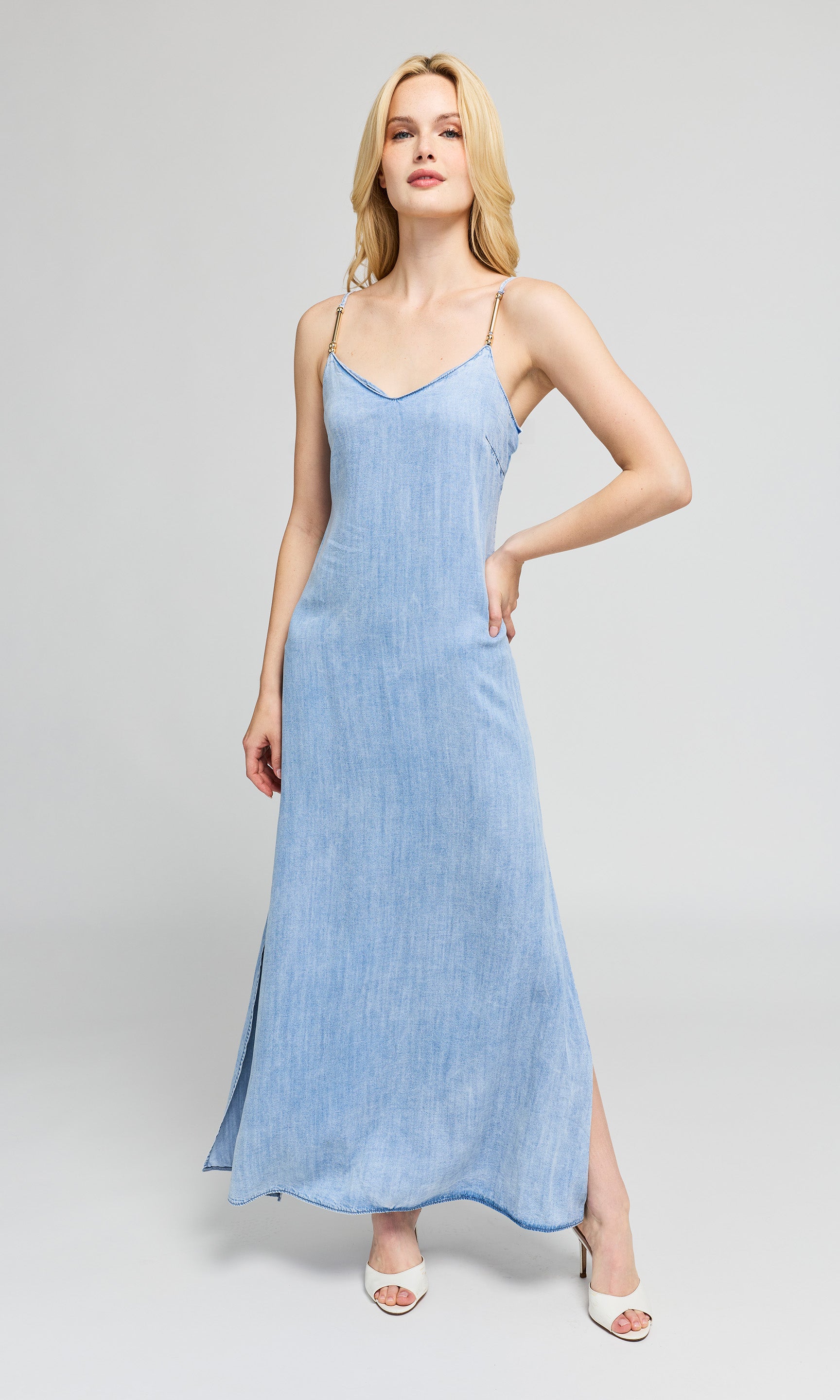 Woman wearing a light blue dress on a gray background