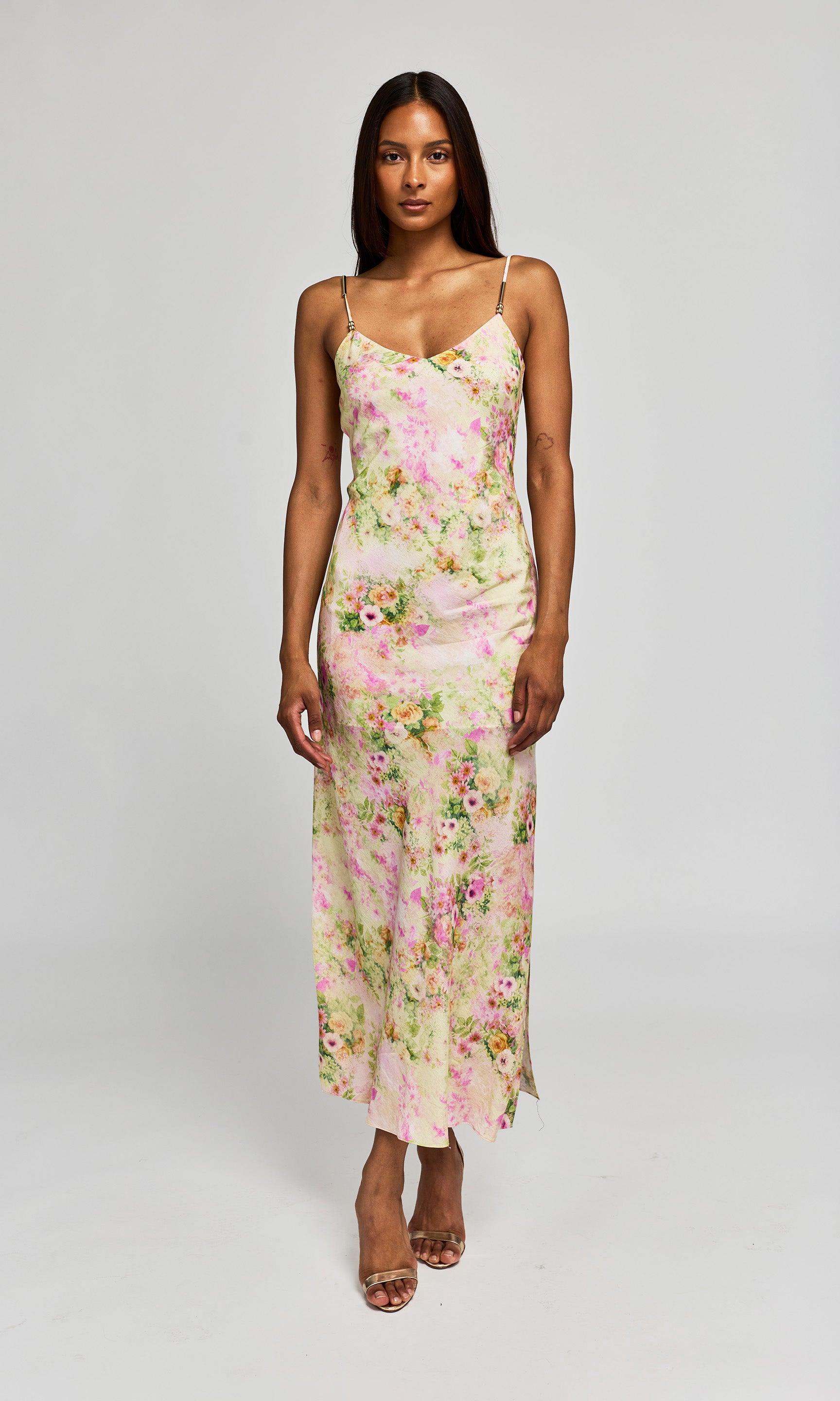 Woman wearing a floral dress on a plain background