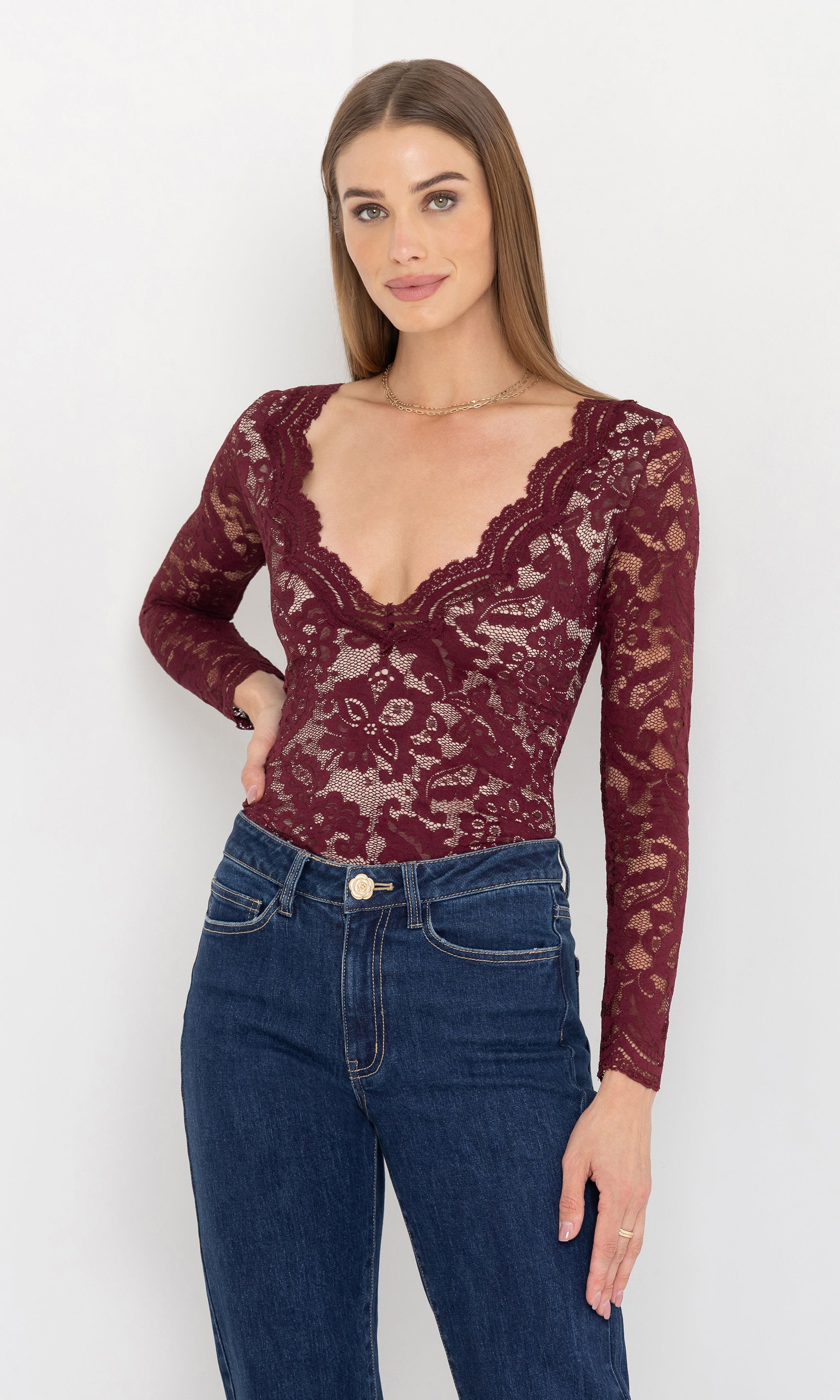 Front view of the model wearing the alessia lace bodysuit with deep v-neckline.