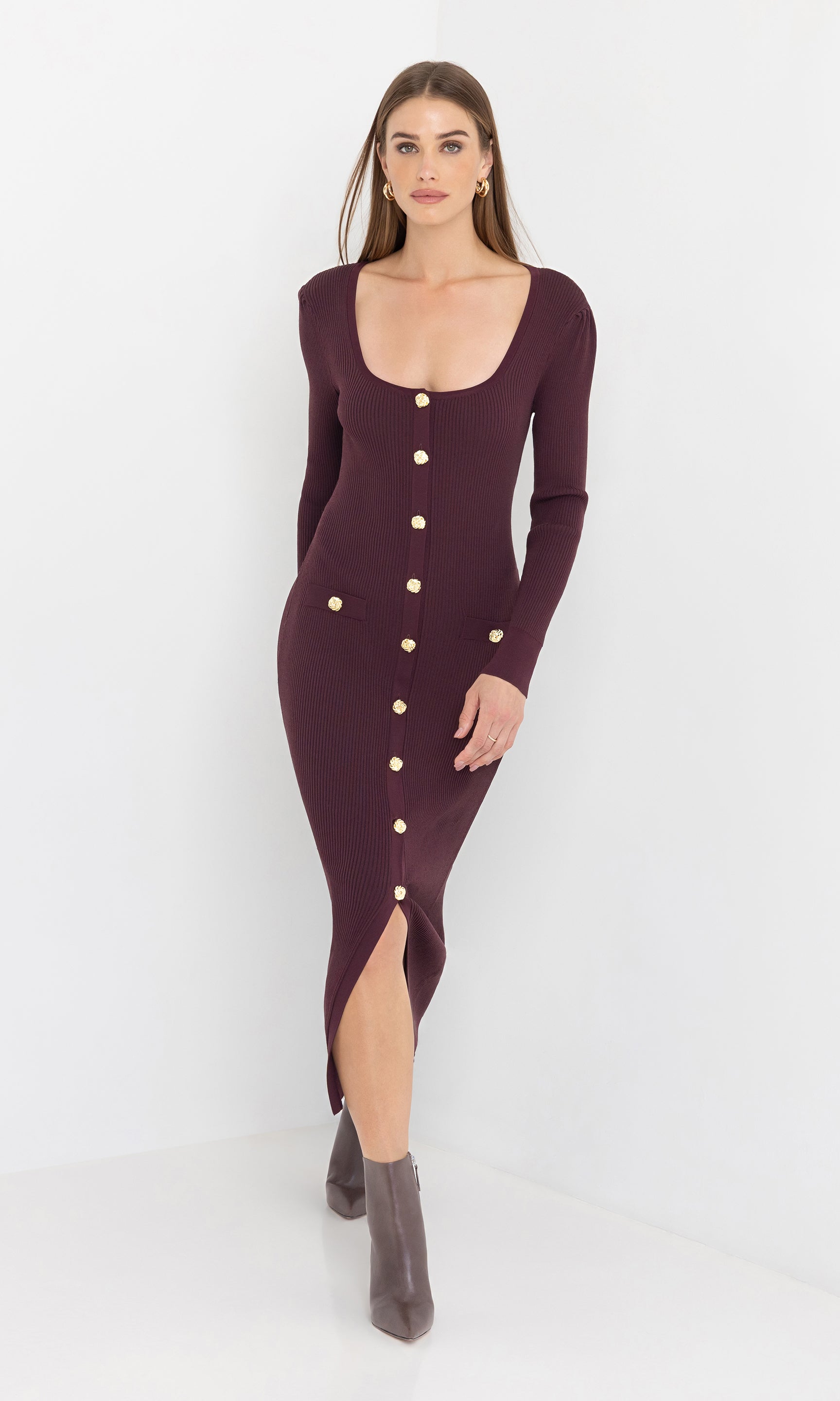 Front view of the model showcasing the andolina square neck dress with long sleeves and slit.