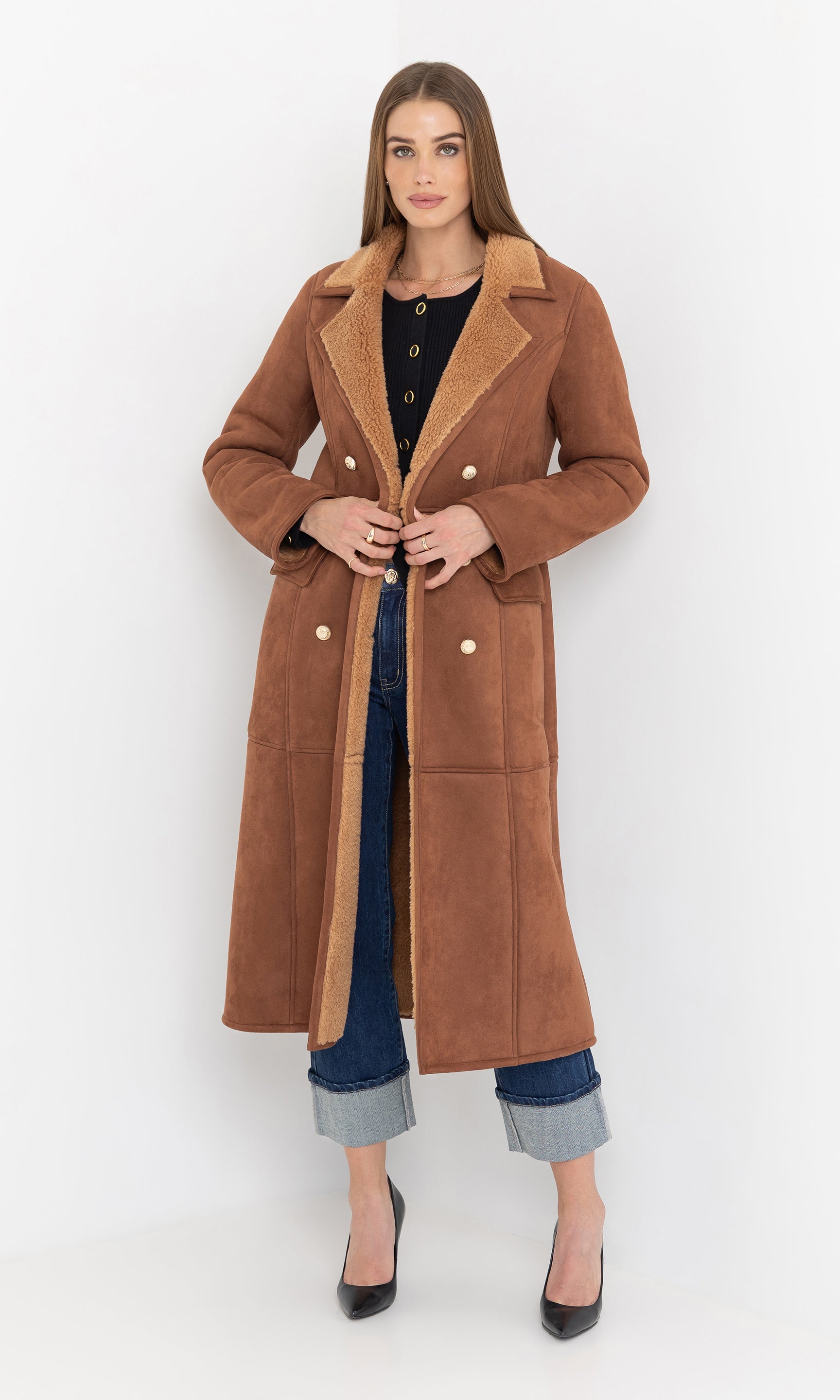 Front view of the model wearing the benton faux shearling coat with button closure.