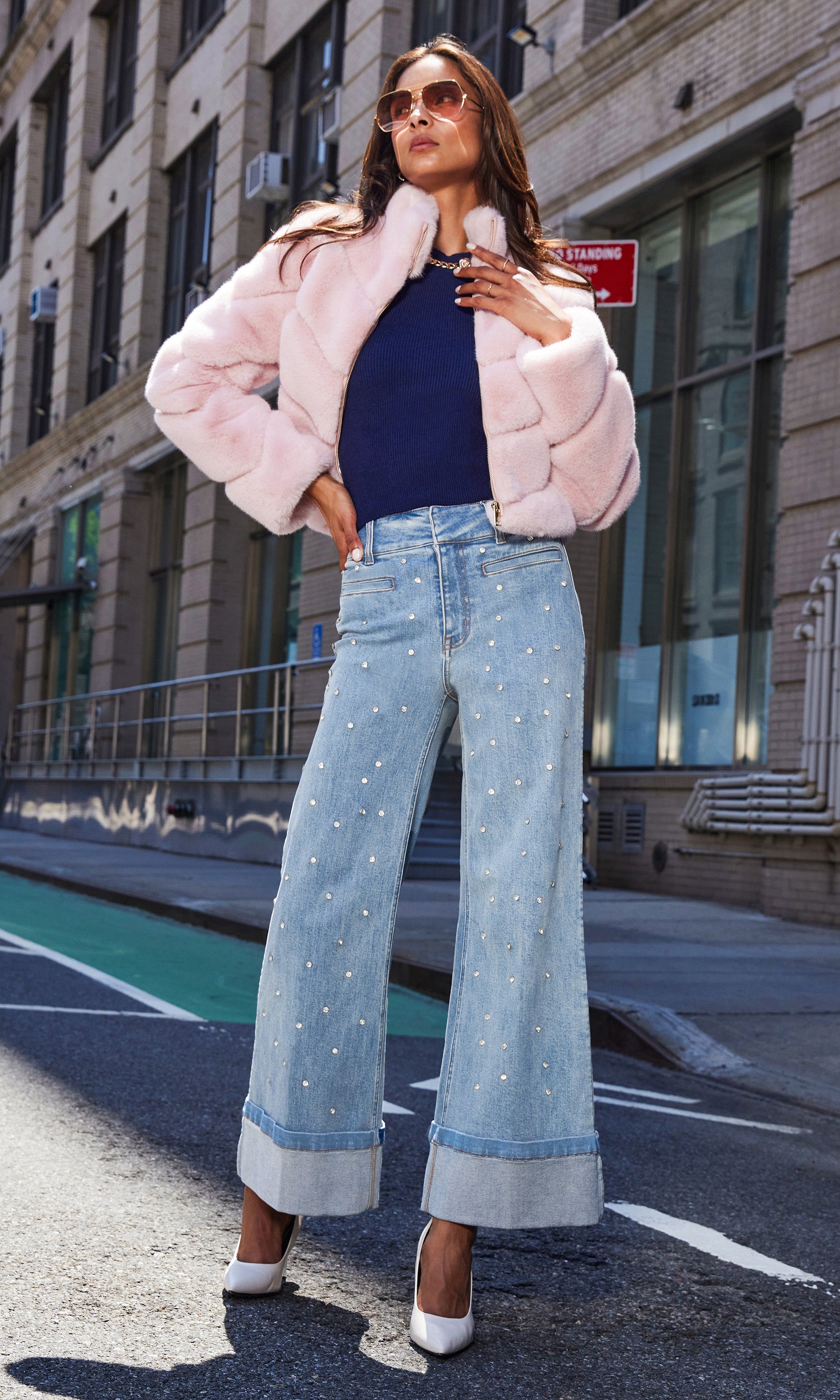Full body front view of the Raquel Crystal Stud Jeans styled with a white top and heels, photographed outdoors.