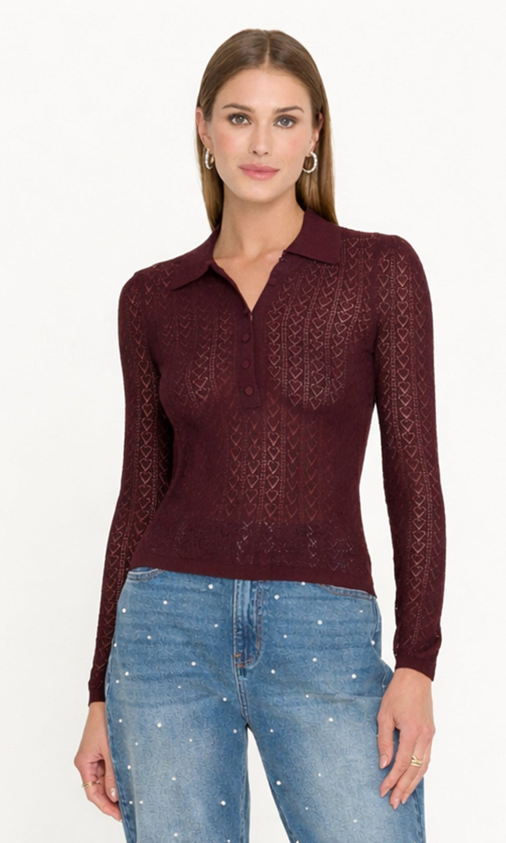 model wears a pointelle sweater with pearl embellished jeans.