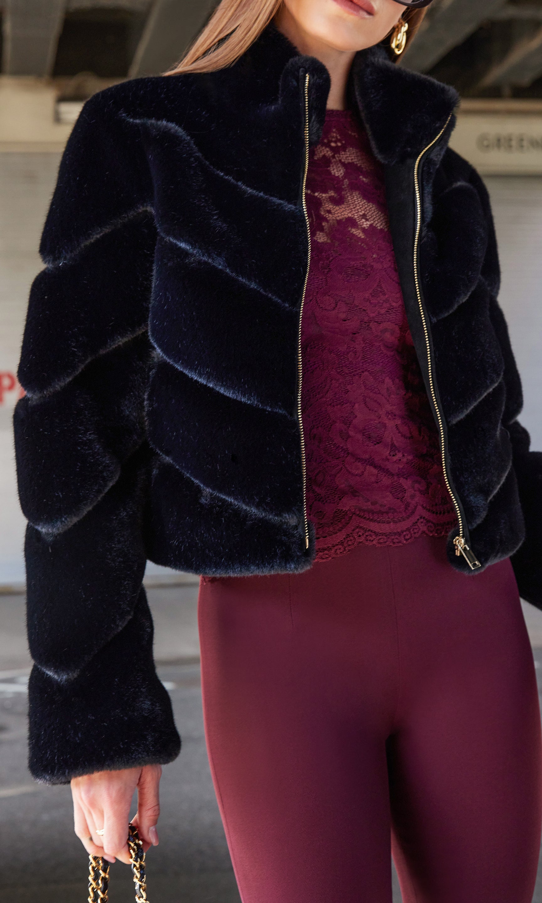 A close-up side view of the model showcasing the Brianna Faux Fur Jacket's soft fur and zipper detail.