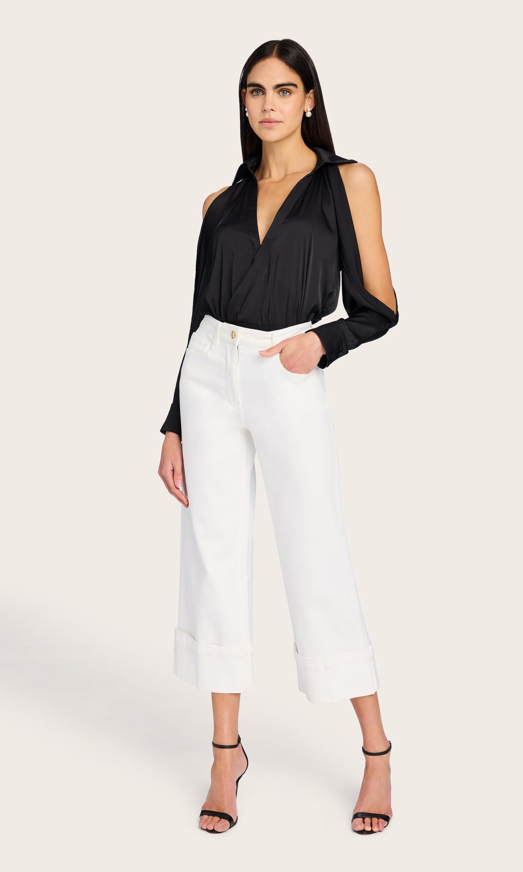 Full body shot showing the Dee Bodysuit paired with light denim and heels, styled for a polished yet edgy look