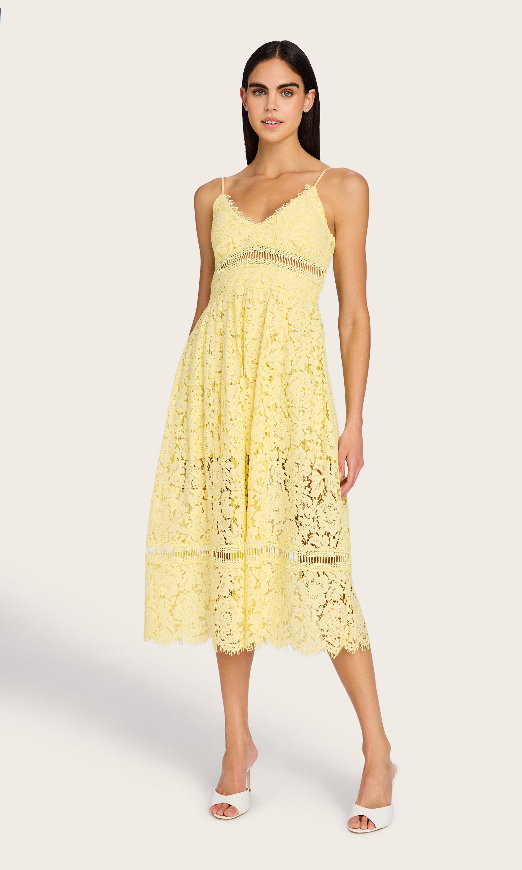 The model poses in the Emma Lace Maxi Dress, showing a full-body front angle that emphasizes the tiered hem and soft structure.