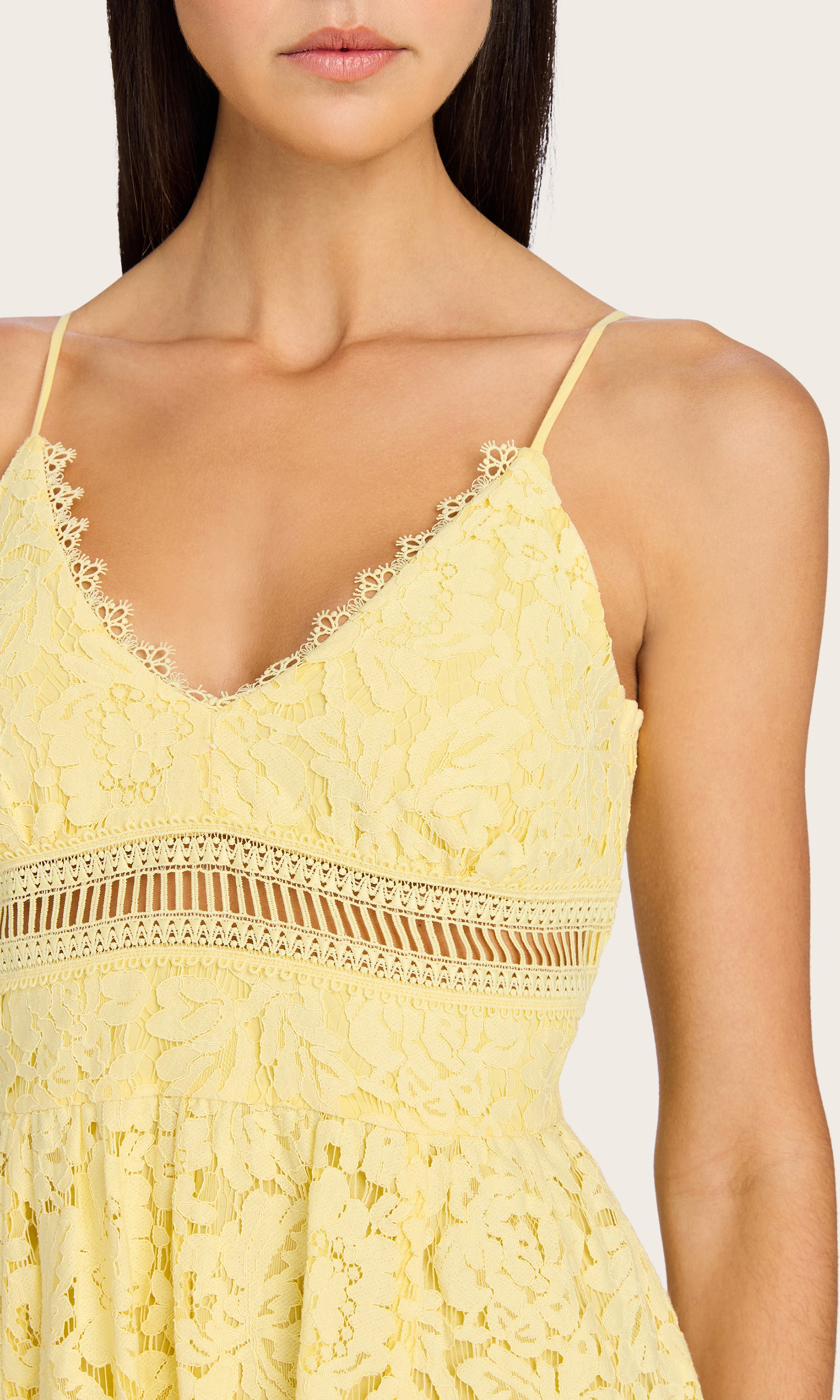 A close-up of the Emma Lace Maxi Dress worn by the model, focusing on the V-neckline and intricate floral lace detail.