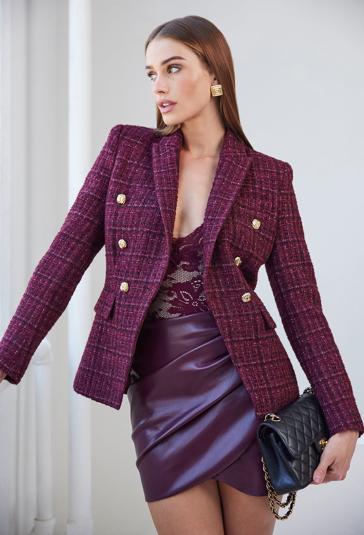 image of model wearing a burgundy outfit: tweed jacket, lace top and vegan leather skirt.