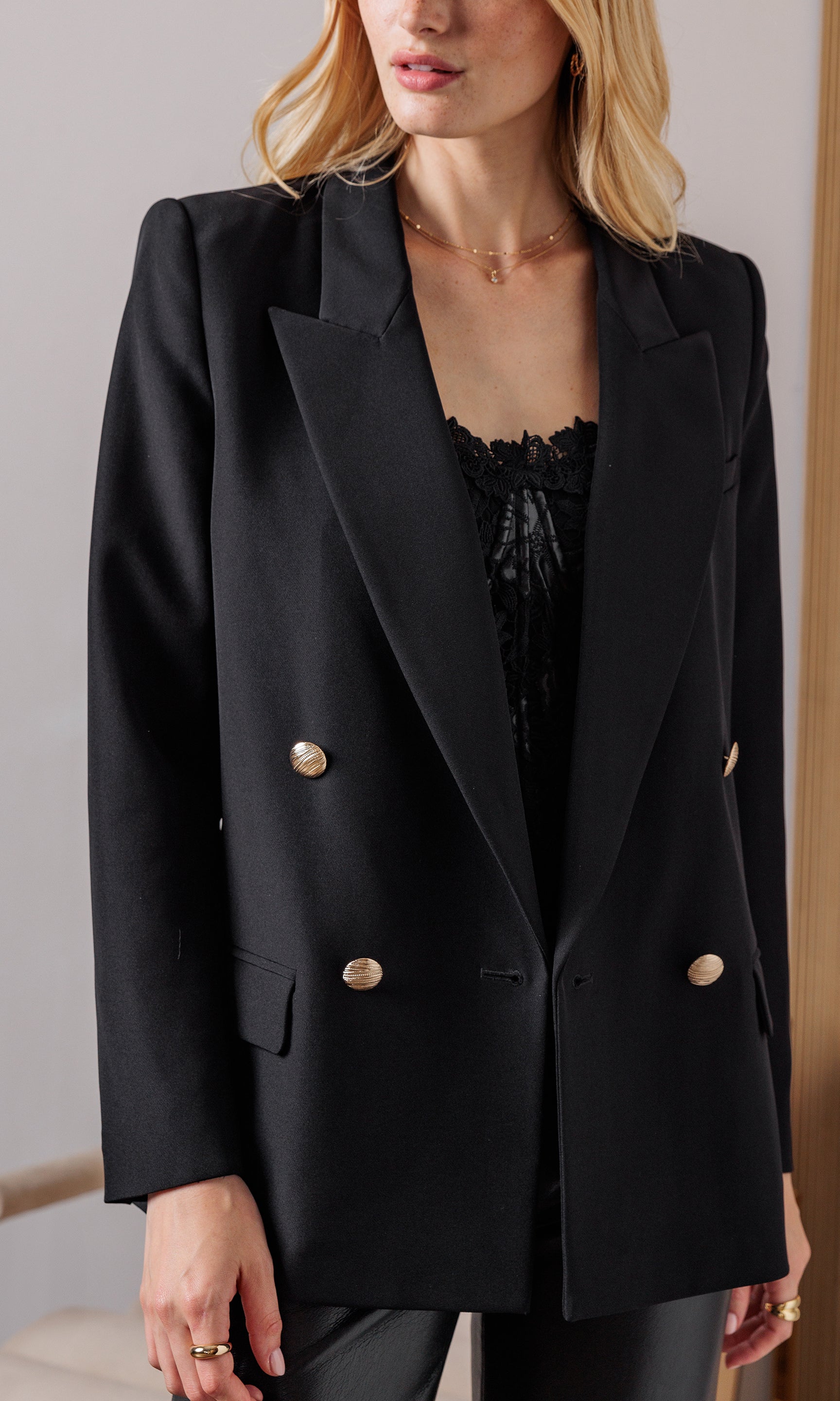 Close-up front view highlighting the gold-tone double-breasted buttons and smooth crepe texture.