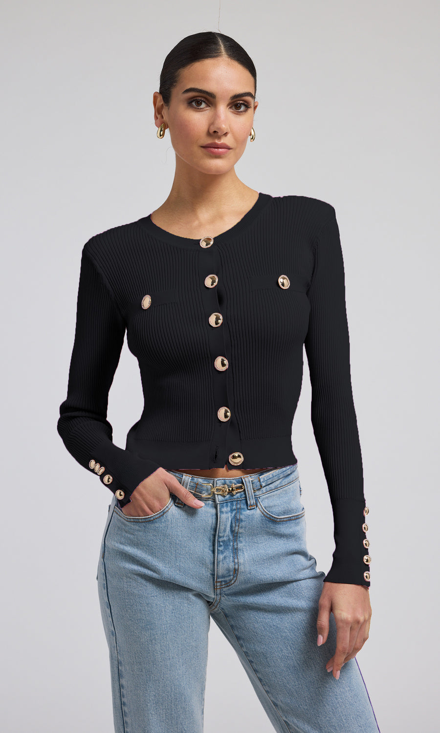 A black ribbed cardigan featuring elegant gold buttons, showcasing a stylish and sophisticated design.