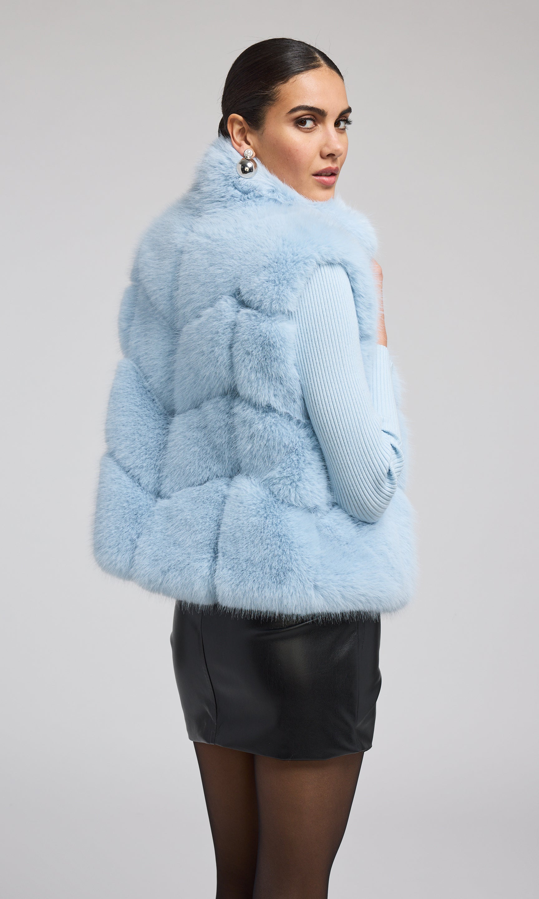 Elegant blue faux fur vest, crafted from high-quality materials, offering a chic and sophisticated look for various occasions.