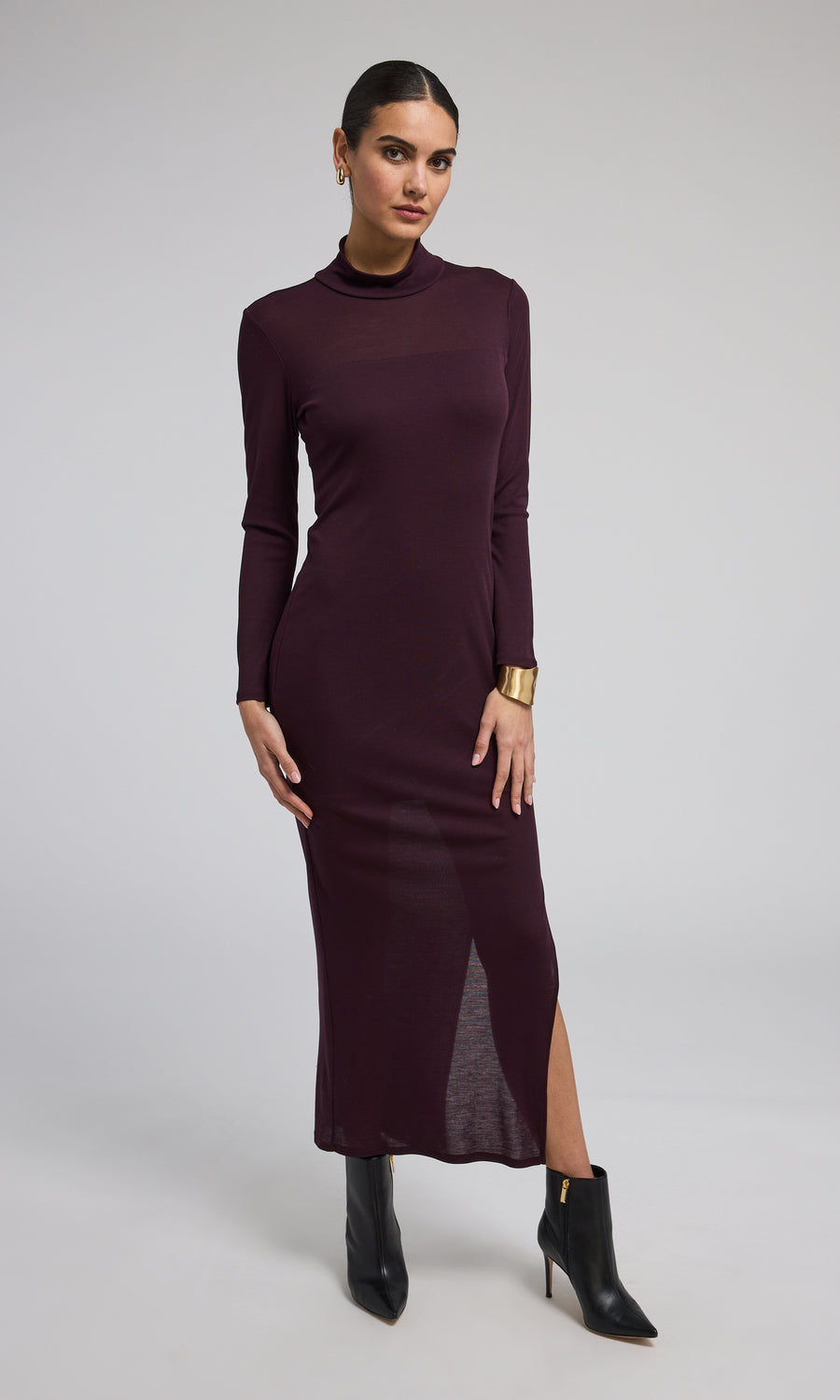 A long-sleeved long dress in a rich burgundy hue, elegantly designed for a sophisticated look.