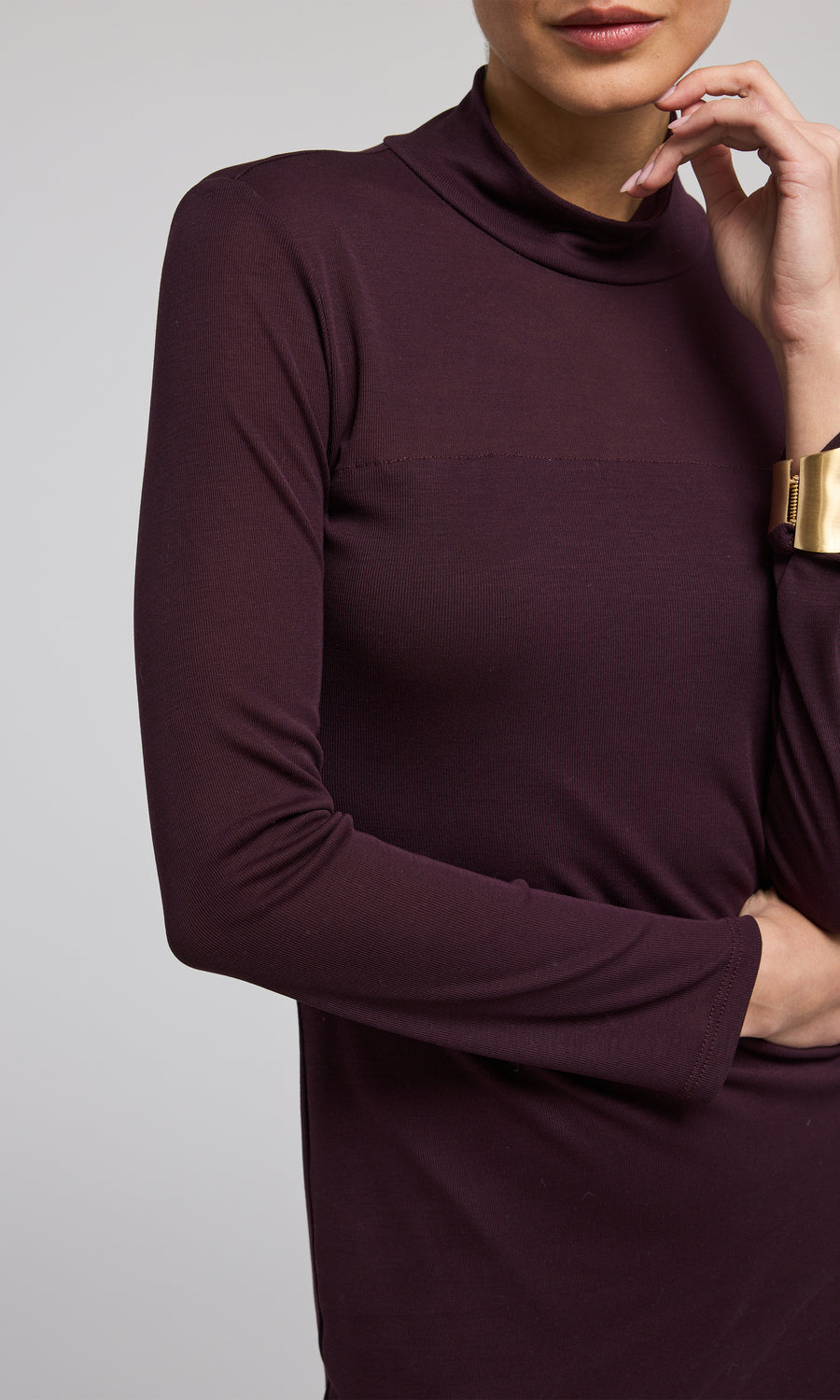 A long-sleeved long dress in a rich burgundy hue, elegantly designed for a sophisticated look.